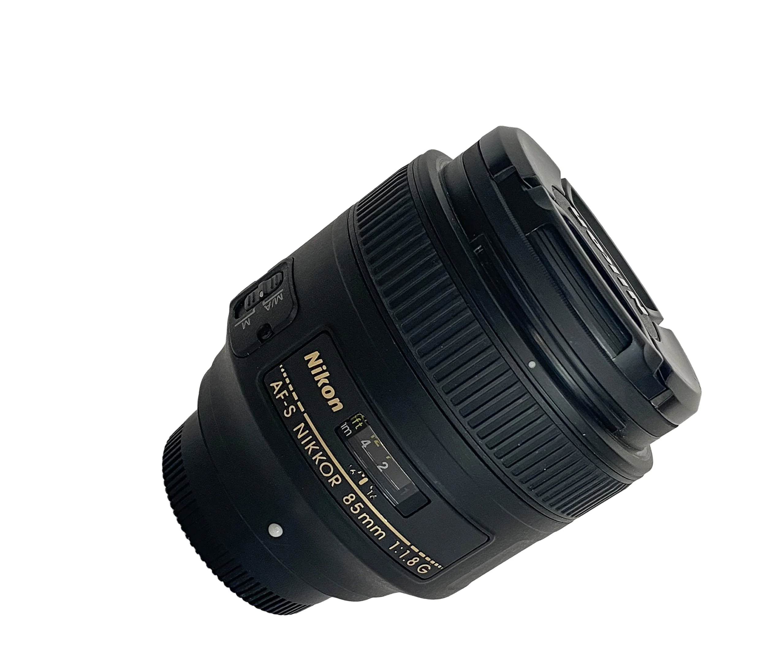 Close-up view of a Nikon camera with a lens and focus ring, showing various camera controls.