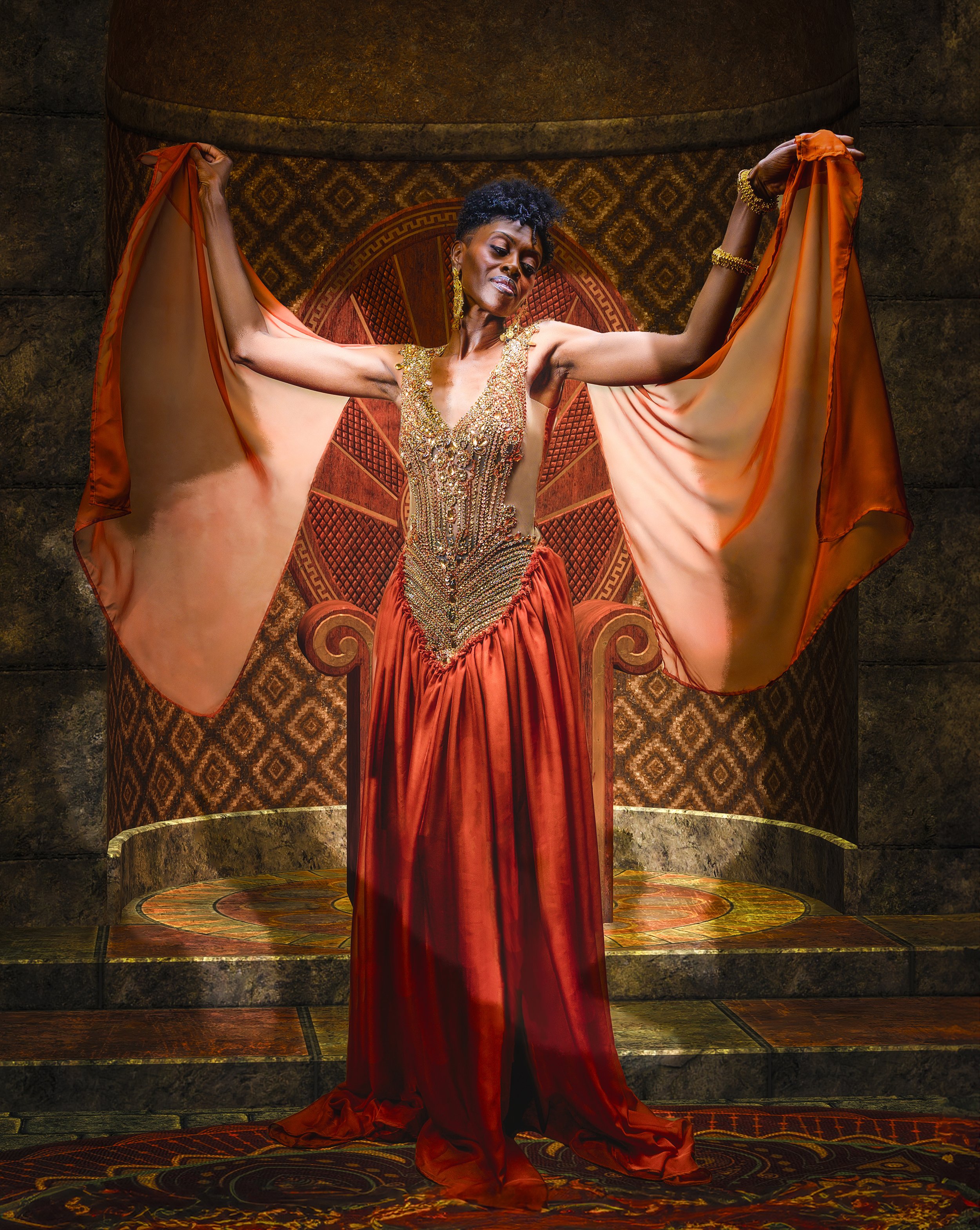 Fine-art portrait of a woman in an elaborate red and gold gown, demonstrating how dramatic wardrobe can become part of the artistic concept of a portrait.