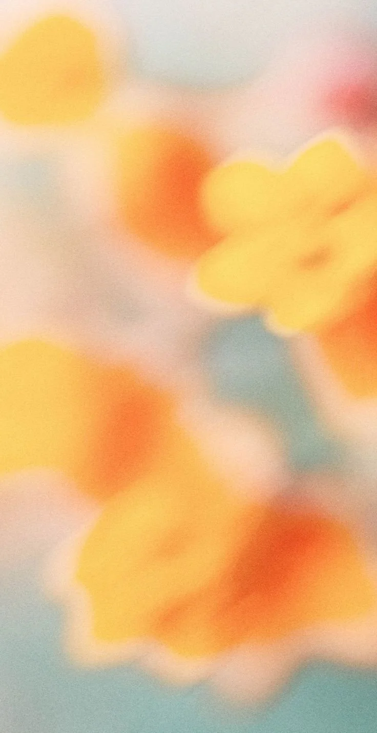 Blurred image with yellow, orange, red, blue, and pink abstract shapes.