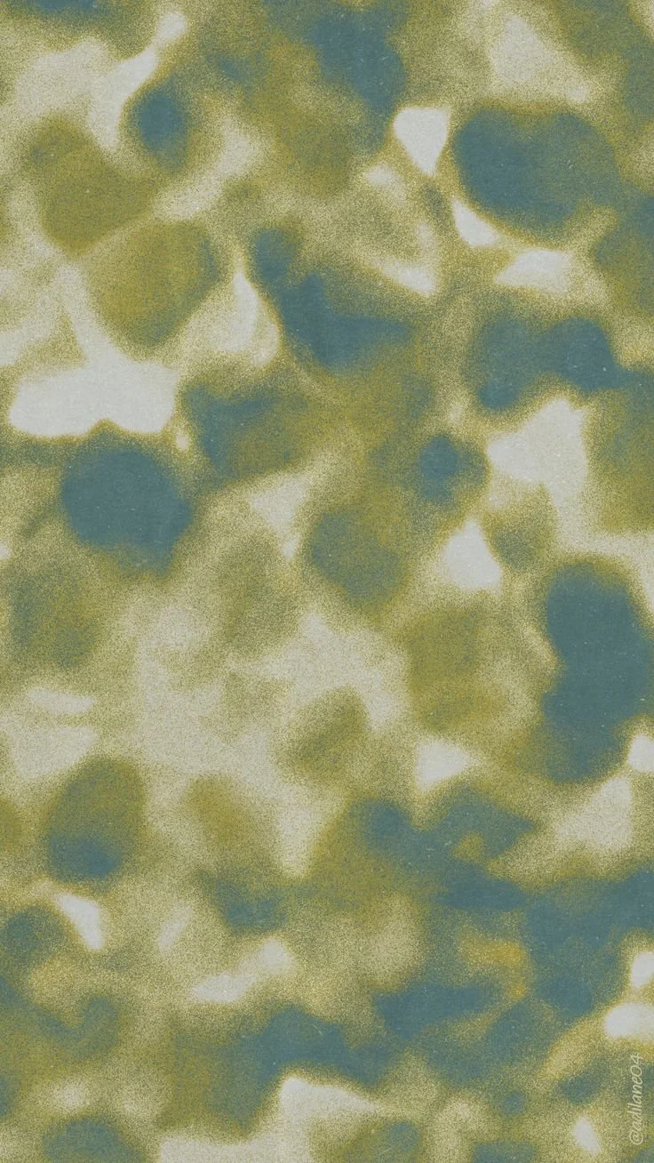 Abstract pattern with green and blue spots on a pale background.
