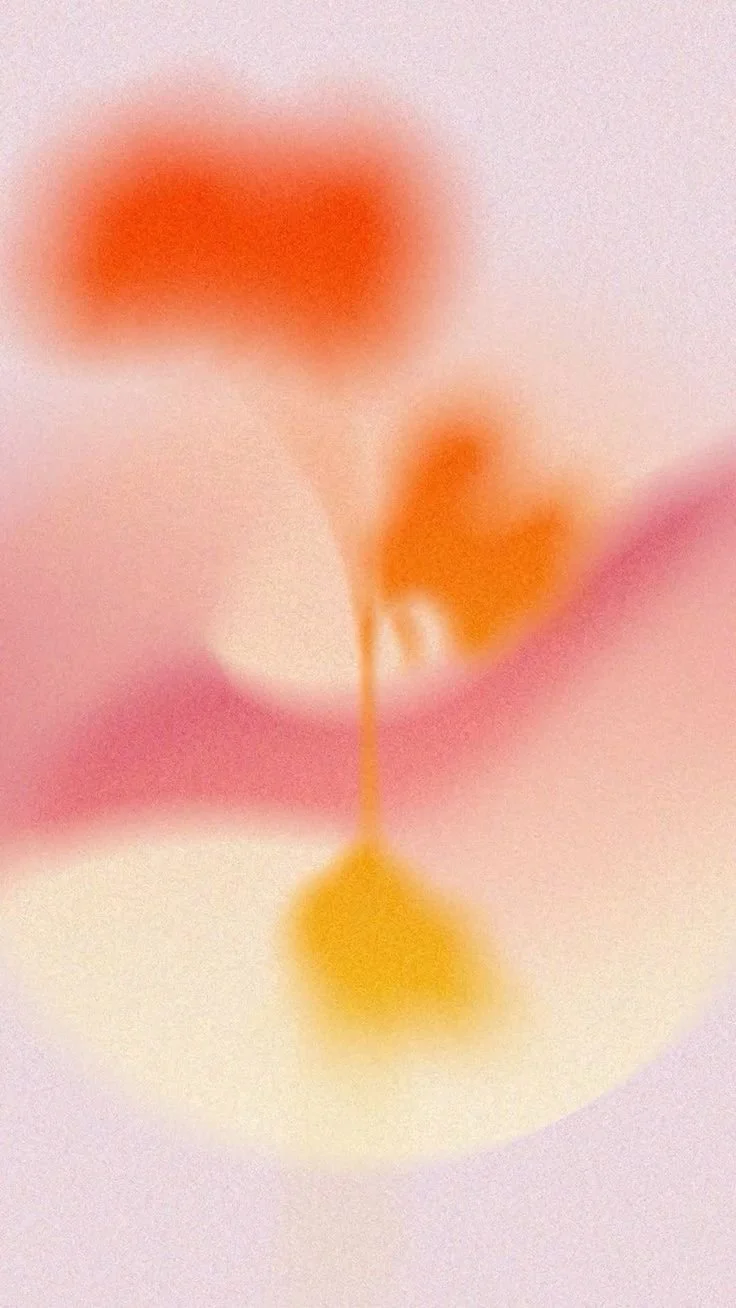 Close-up of a cherry with a soft pink background and blurred colors.
