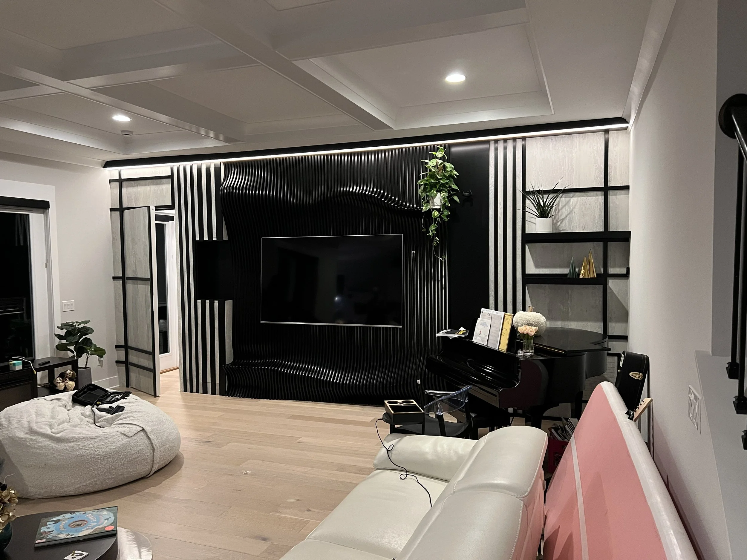 Modern entertainment unit with a parametric wall and hidden door.
