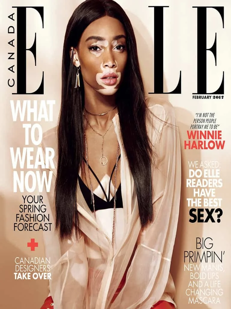 Winnie Harlow on Elle magazine cover, February 2019, wearing a sheer beige top with layered necklaces, dark hair, and makeup.