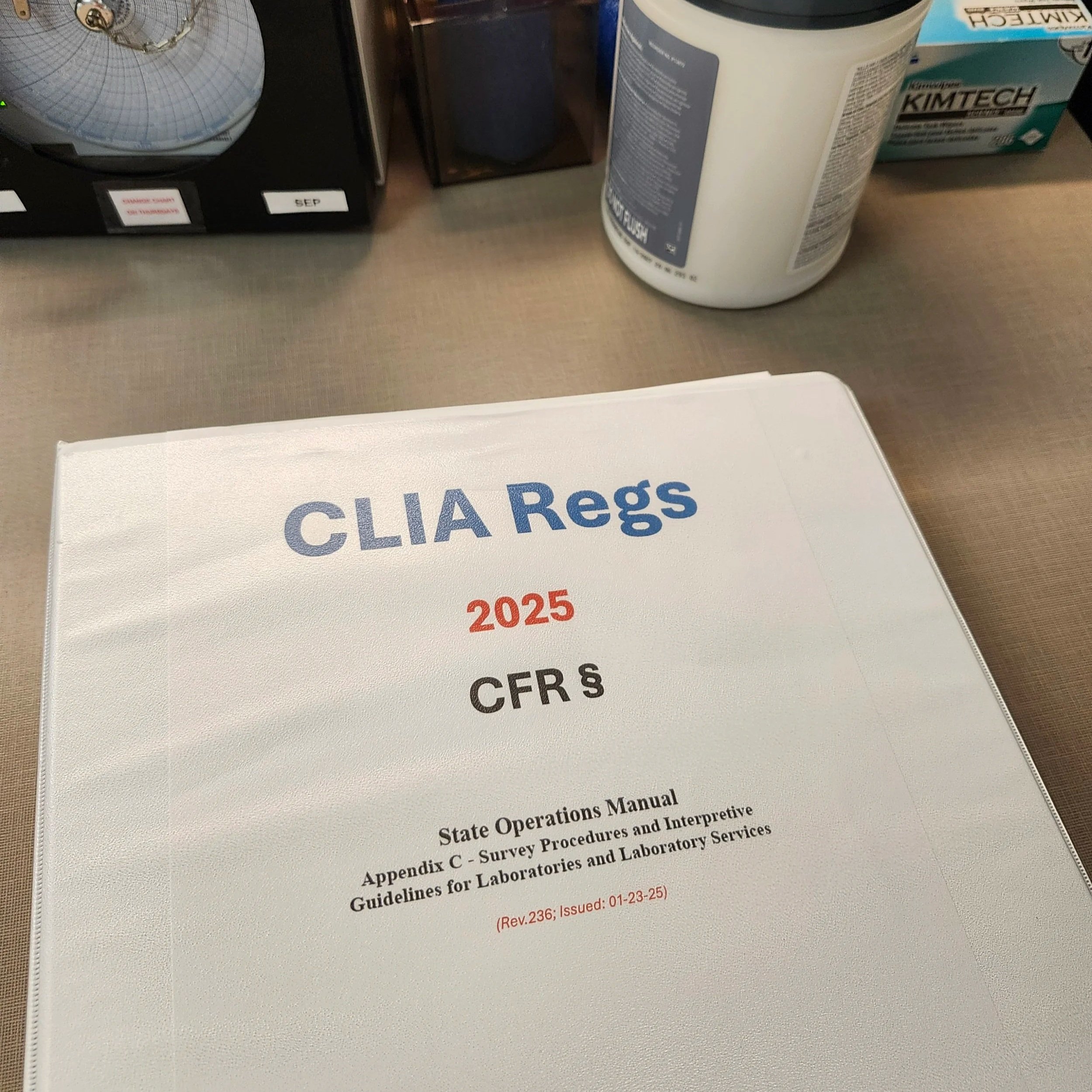 Image of a three ring binder labeled CLIA Regs, the year 2025, CFR, State Operations Manual