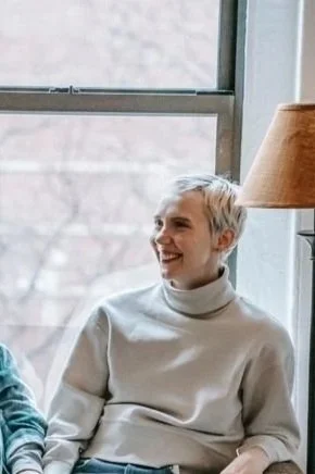 Woman sitting by window and smiling