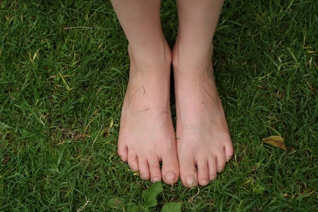 feet standing on grass