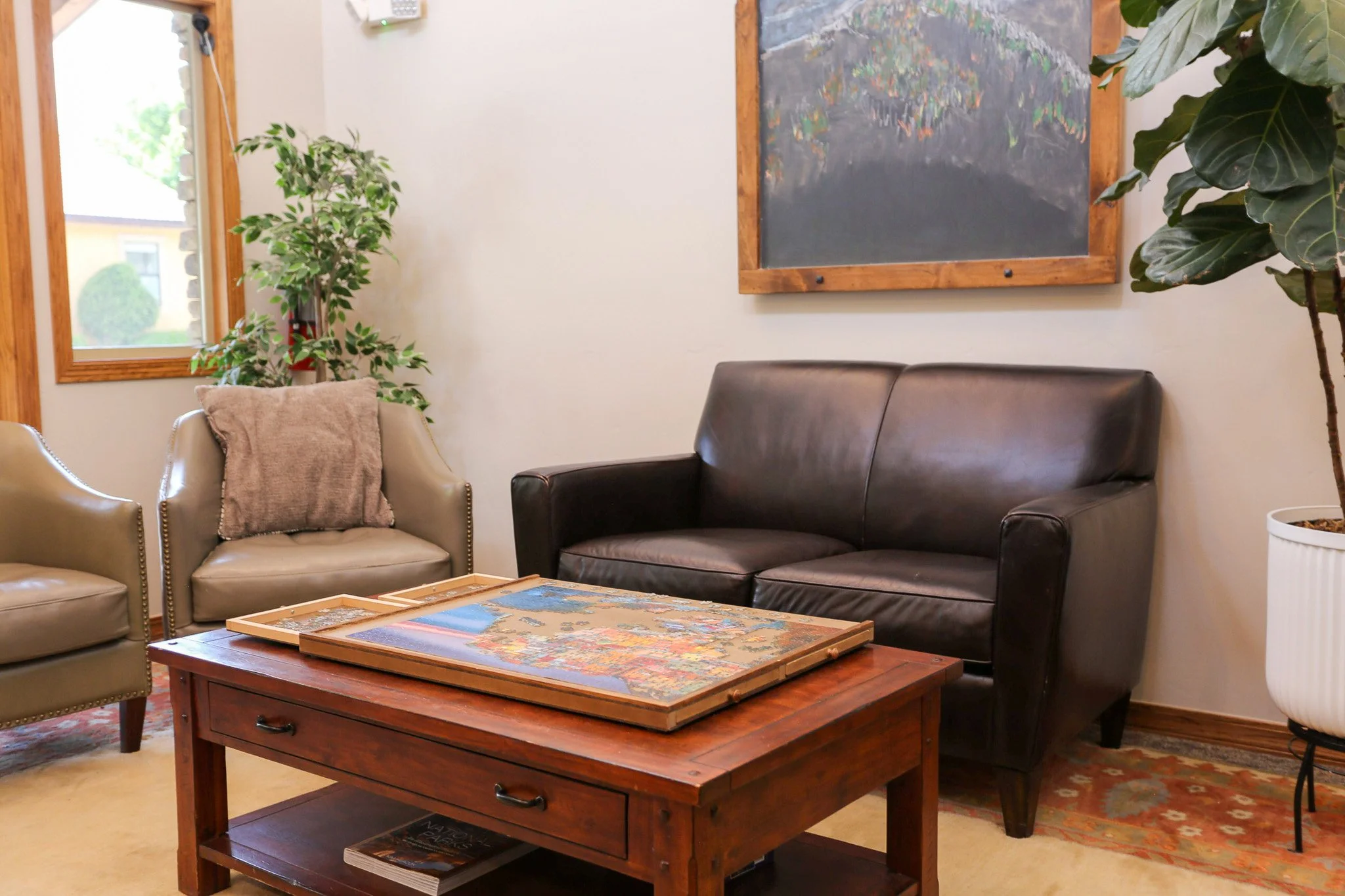 A seating area at Wind Rivers Counseling with a puzzle set out on a coffee table.