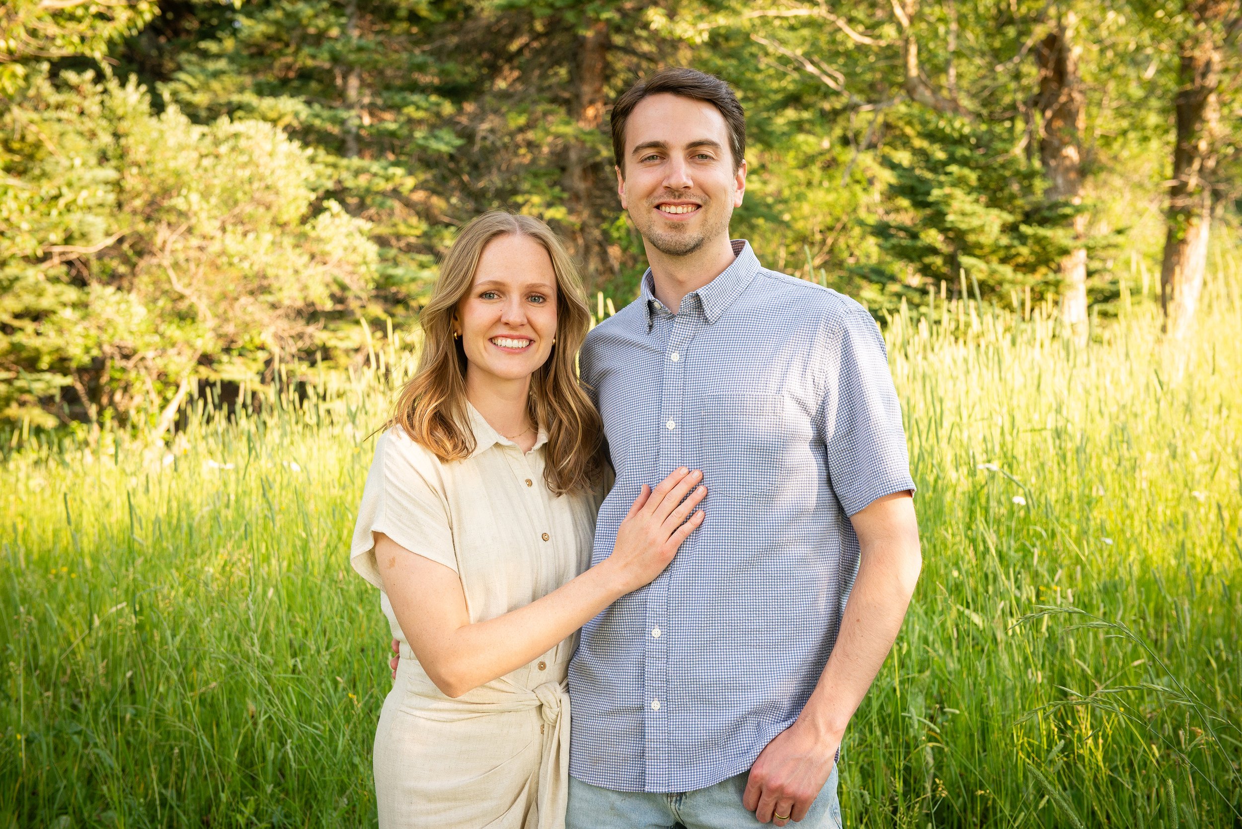 Austin Hansen and his wife smiling in an open field