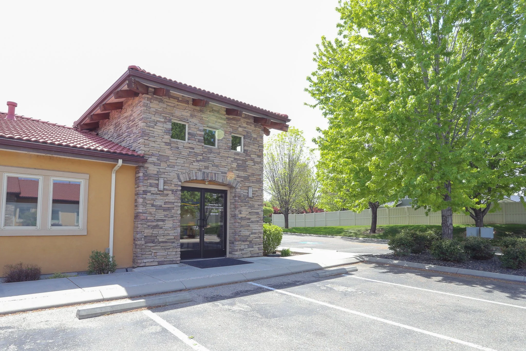 The rear entrance of Wind Rivers Counseling and an empty parking lot.