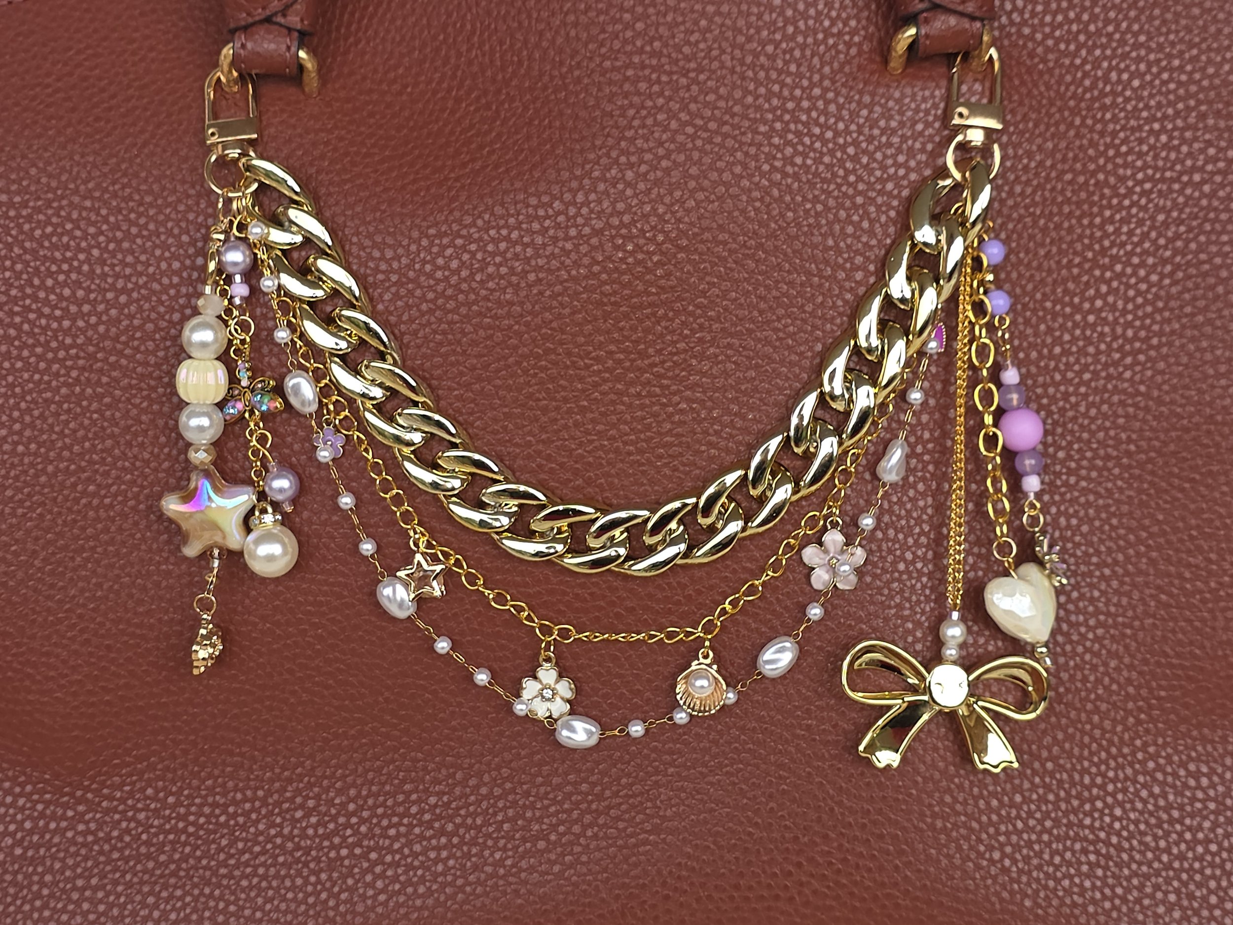 Gold bag chain with lilac enamel flower charms, pearls and large acrylic bow — The Wisteria Hoard by Charm & Delight