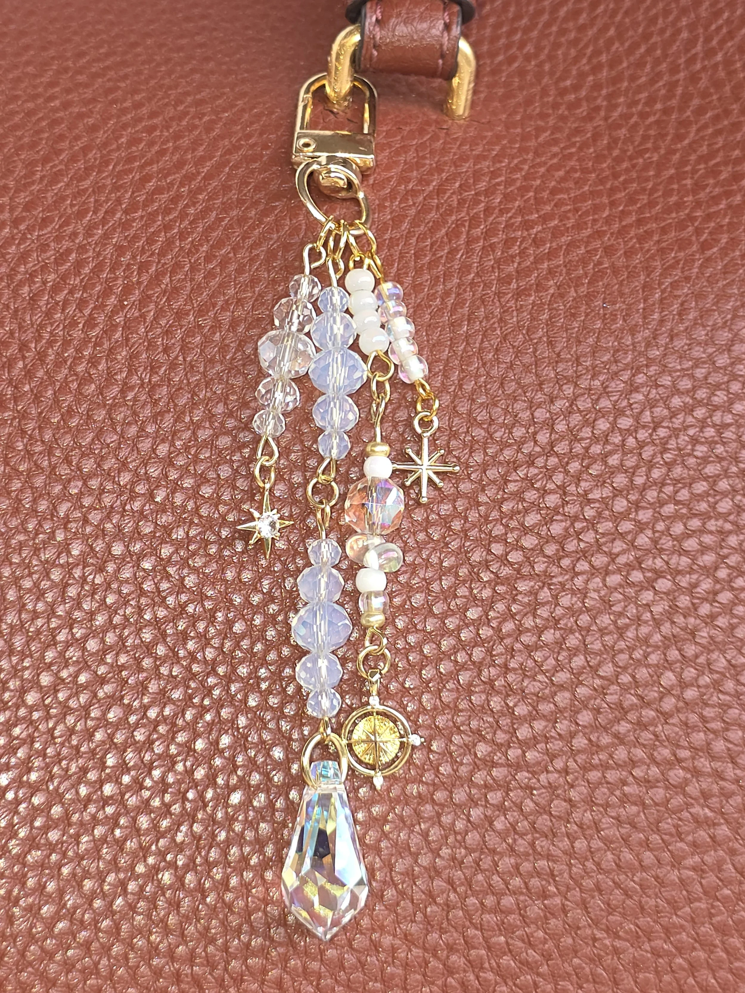 Gold bag charm with north star and compass charms and faceted glass teardrop — The North Star by Charm & Delight