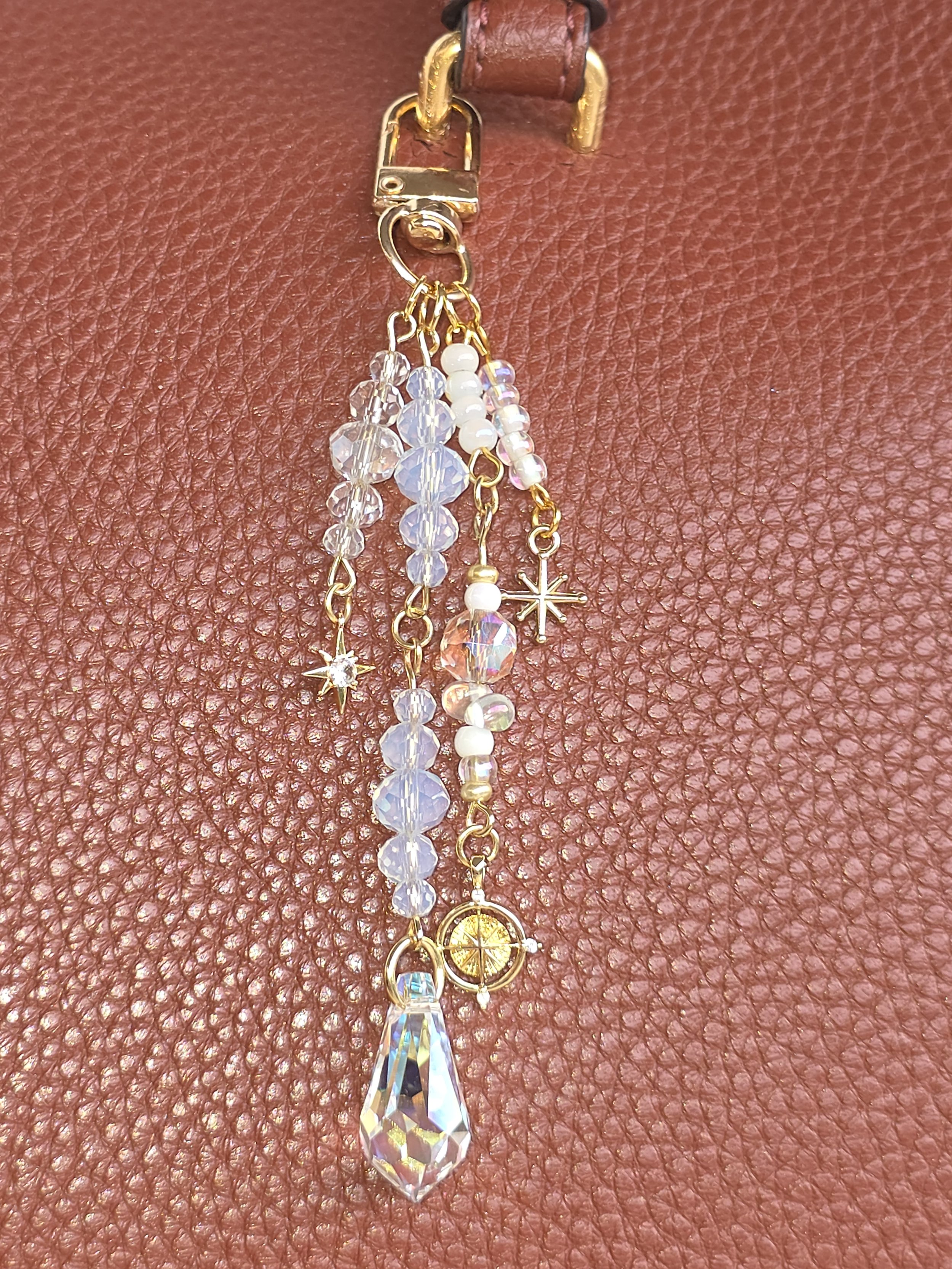 Gold bag charm with north star and compass charms and faceted glass teardrop — The North Star by Charm & Delight