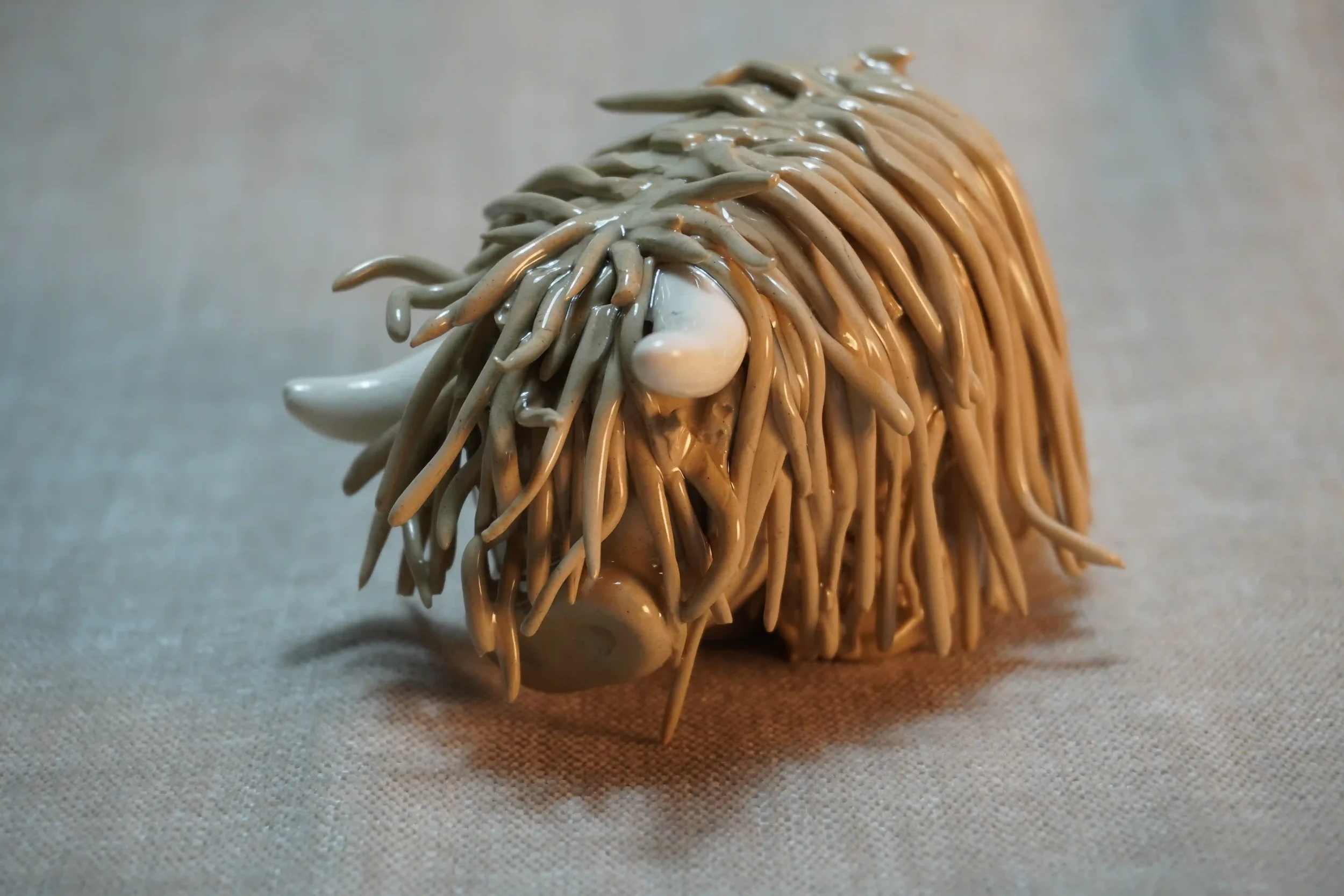 A handcrafted Pottery brown Highland Cow ceramic Ornament