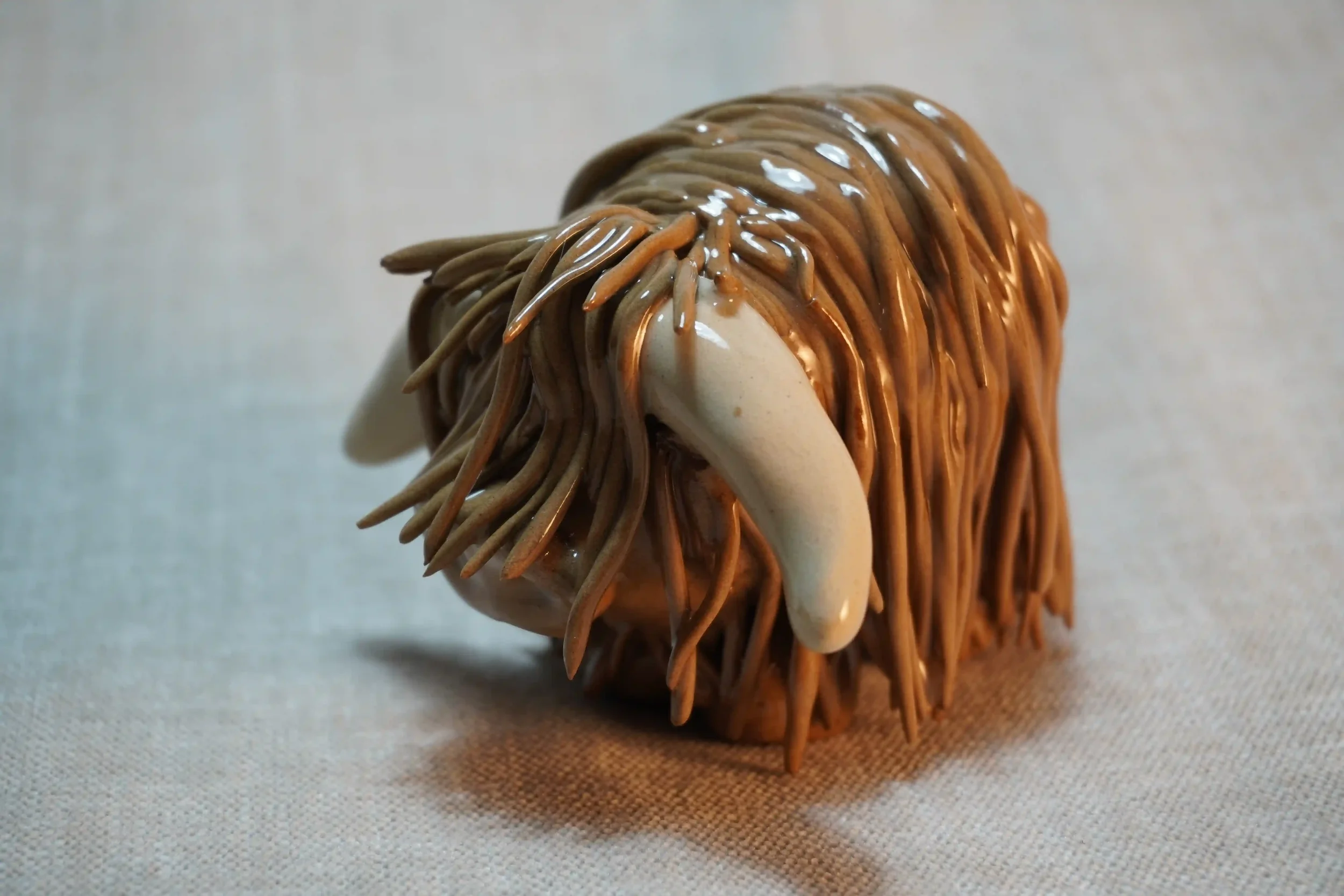 A handcrafted Pottery brown Highland Cow ceramic Ornament