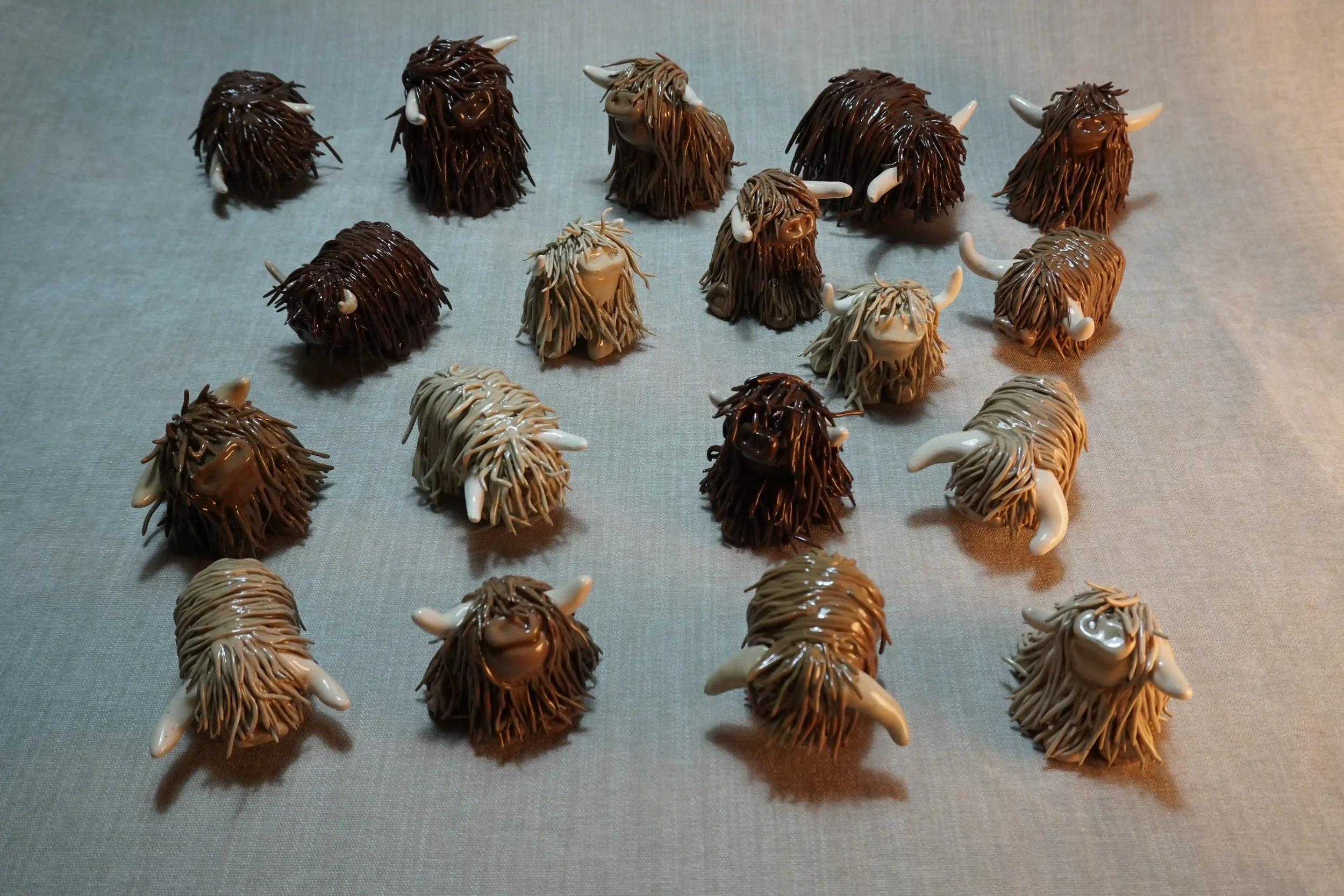 A herd of handcrafted Pottery Highland Cow ceramic Ornaments