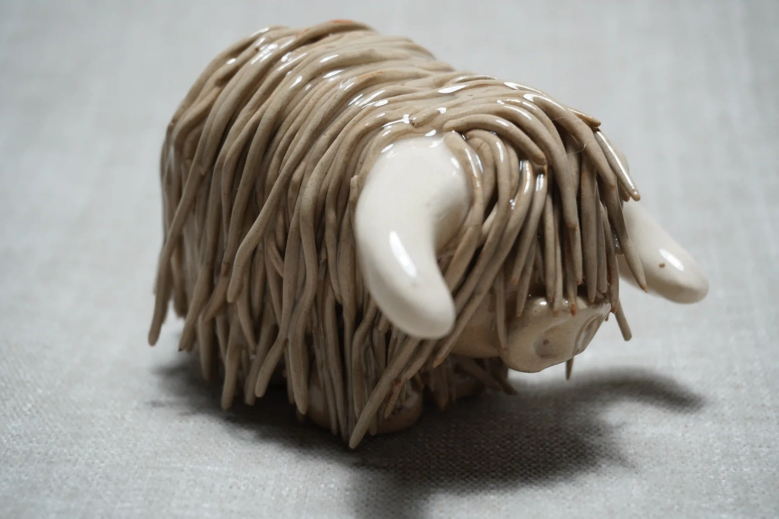 A handcrafted Pottery brown Highland Cow ceramic Ornament