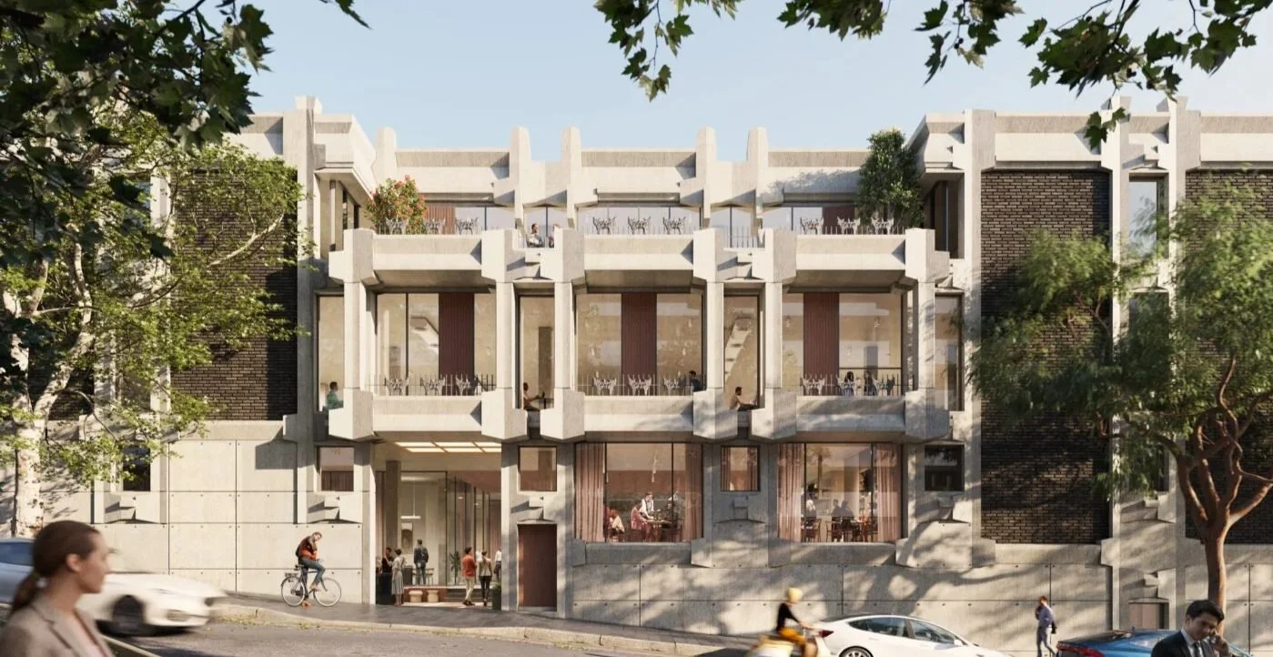 Modern multi-story building with large windows, balconies, and a textured facade, surrounded by trees on a city street.