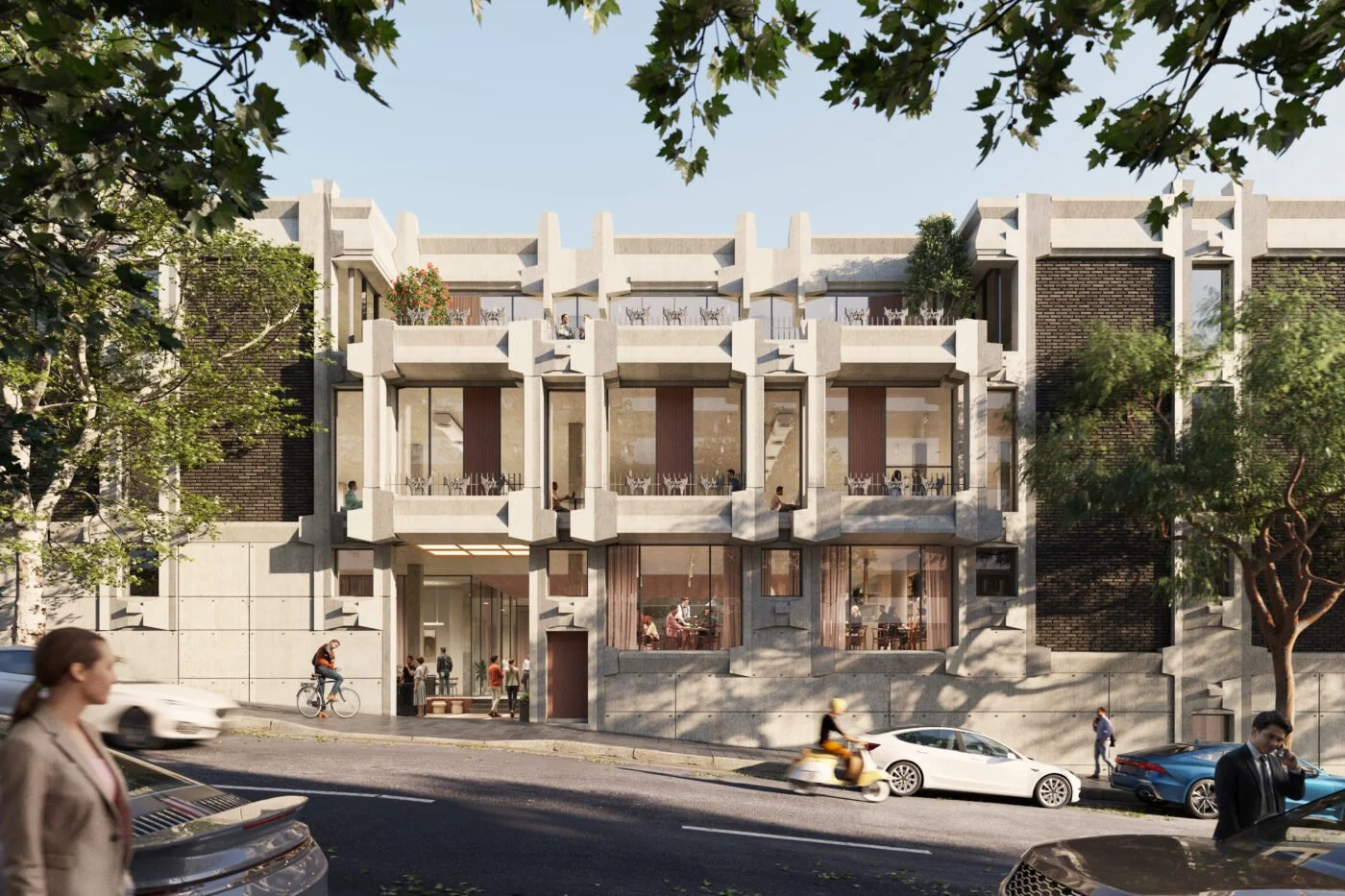 Modern multi-story building with large glass windows, balconies, and unique concrete architectural elements, surrounded by trees and pedestrians on the street.