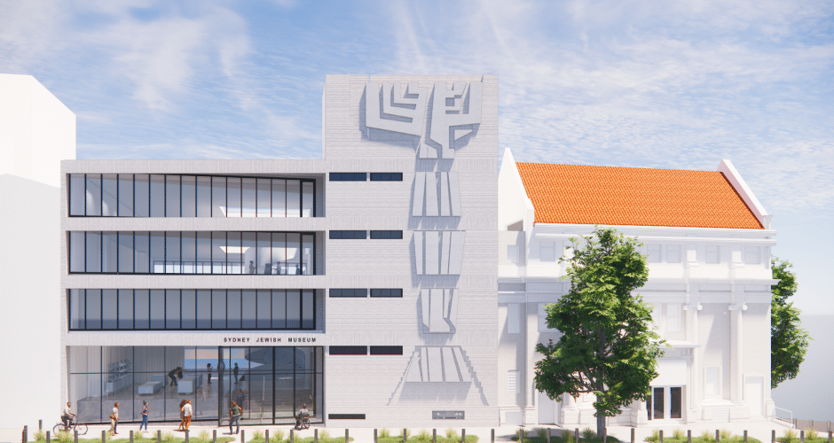 A modern building with glass windows and a decorative facade alongside a classical white building with a red-tiled roof, trees, and people outside.