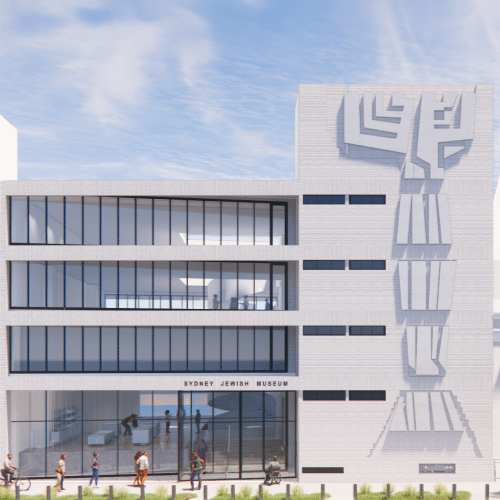 Front view of the Sydney Jewish Museum building, featuring large glass windows on the ground floor and a modern architectural design with a distinctive abstract sculpture on the right side of the facade.