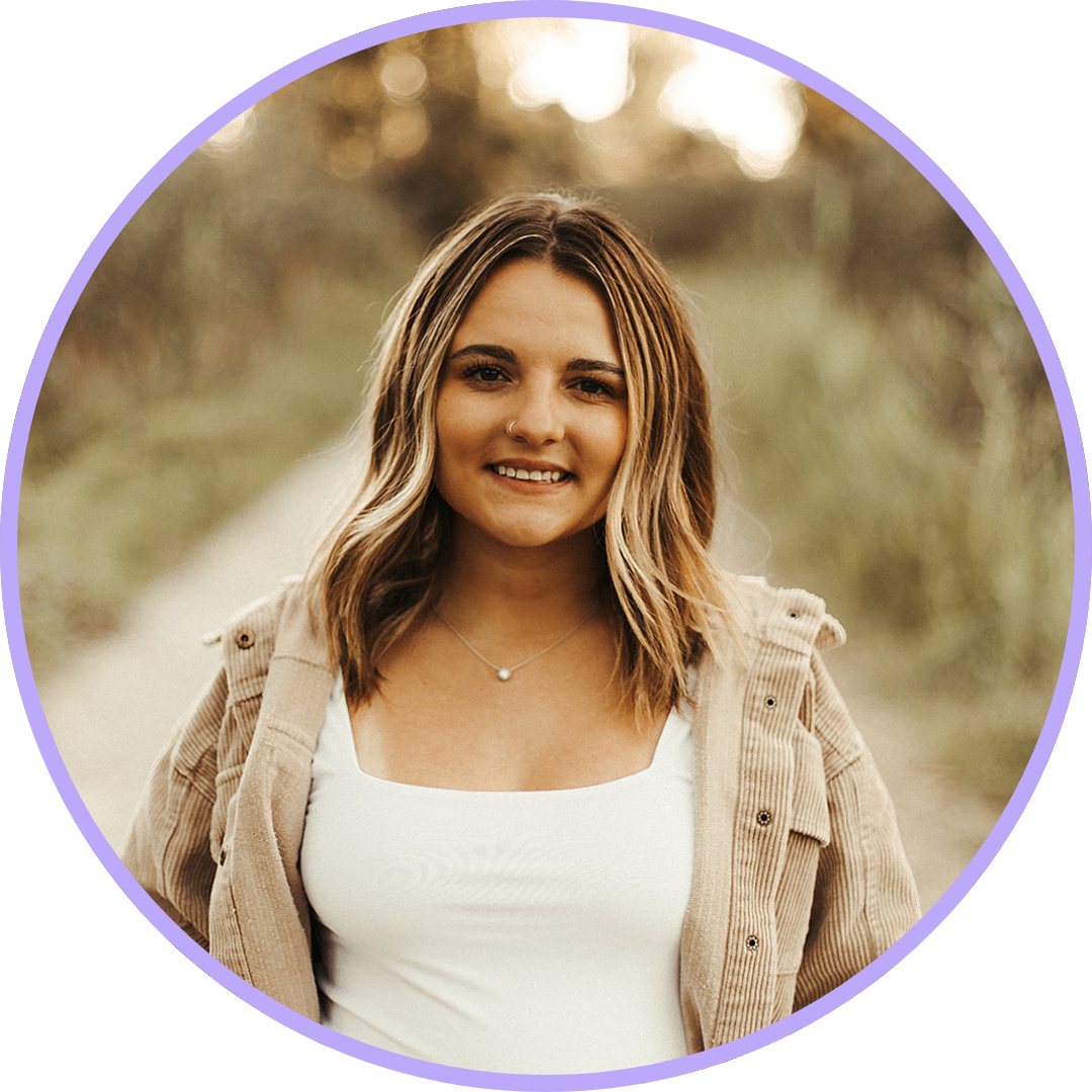 Cloey Coffman, wearing a white top and a brown jacket with short, brown hair and a warm smile.
