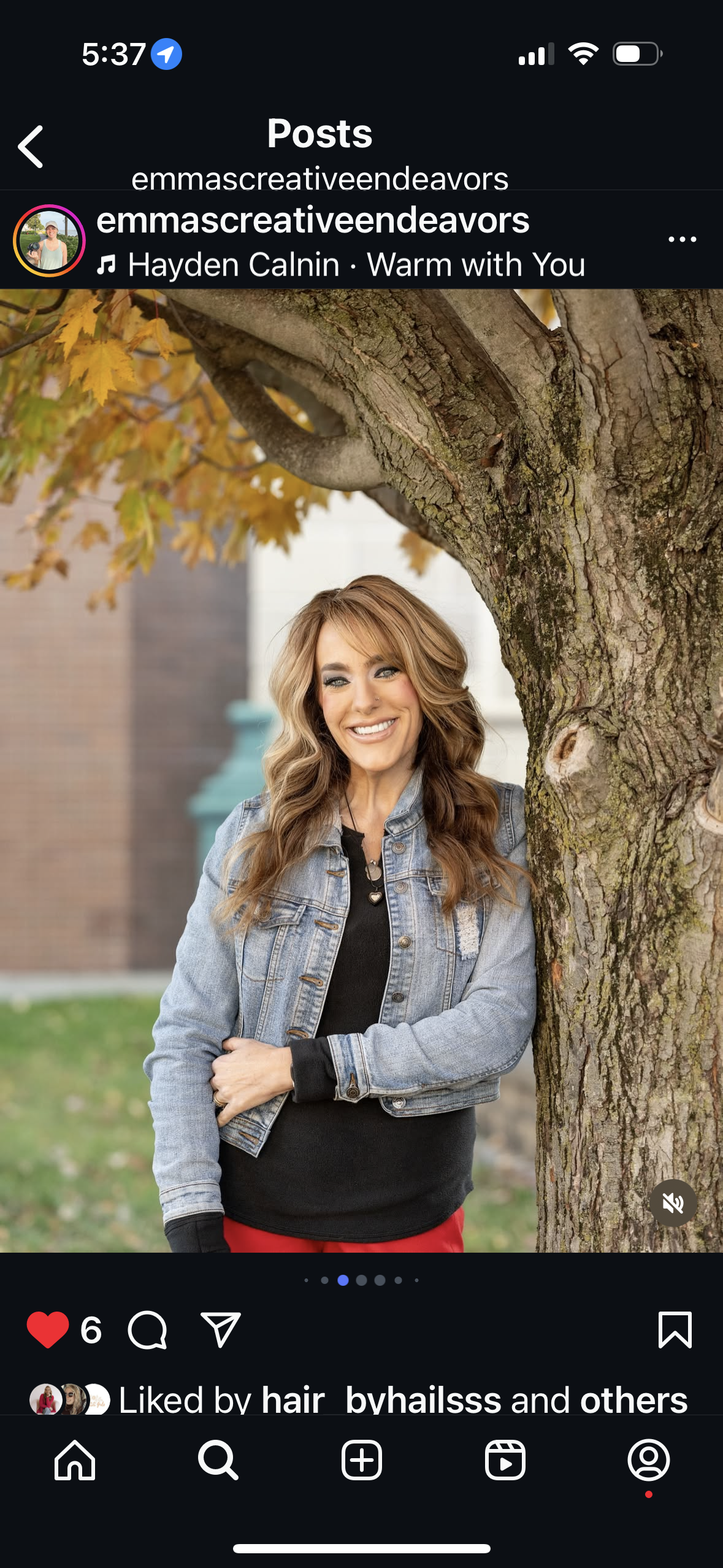 Mandy Prince-Smith, with long brown hair, wearing a black long sleeve under a denim jacket and a welcoming smile.