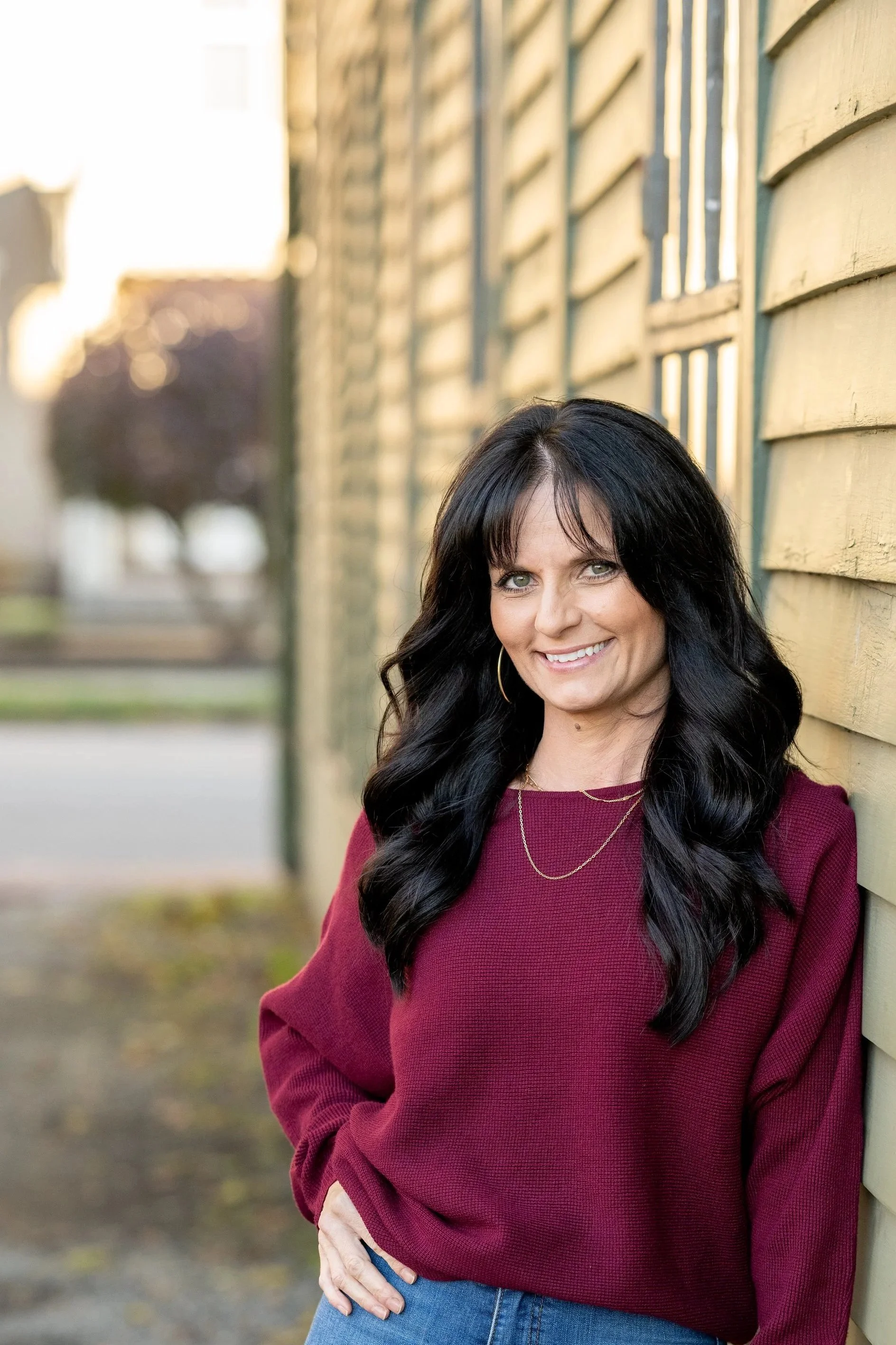 Vanessa Bryan, wearing a maroon top with long black hair and a warm smile.