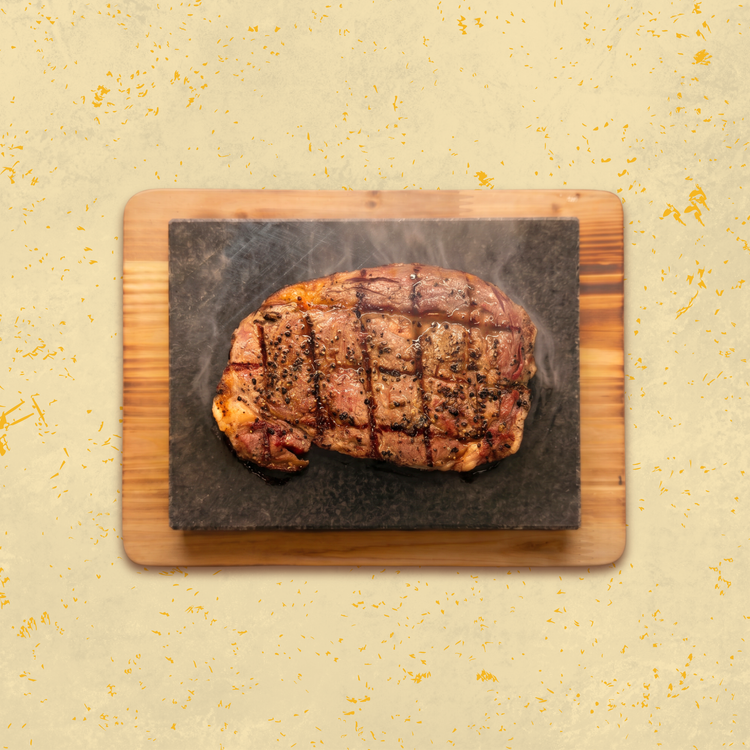 Hotstone steak sizzling on a stone at Old Man's Grill