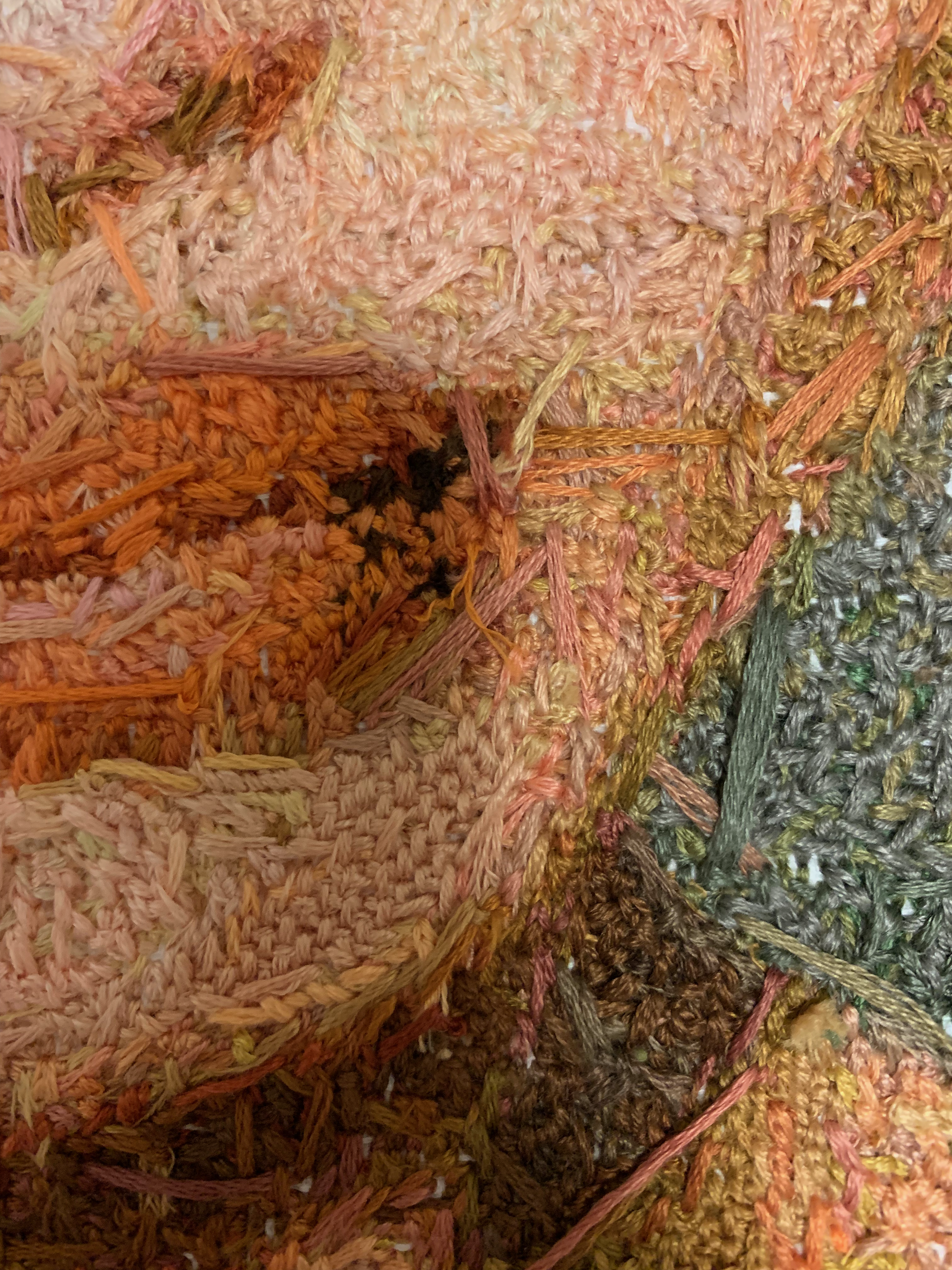 detailed image of hand-stitched needlepoint portrait, close up of the backside of artwork
