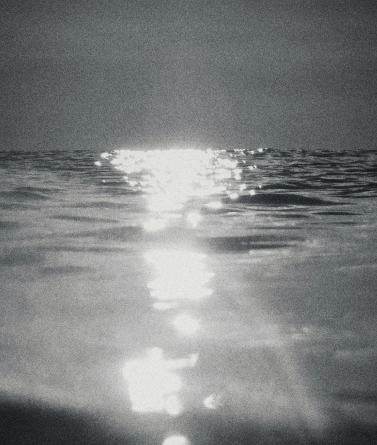 Sun reflecting on the surface of the ocean at sunset or sunrise.
