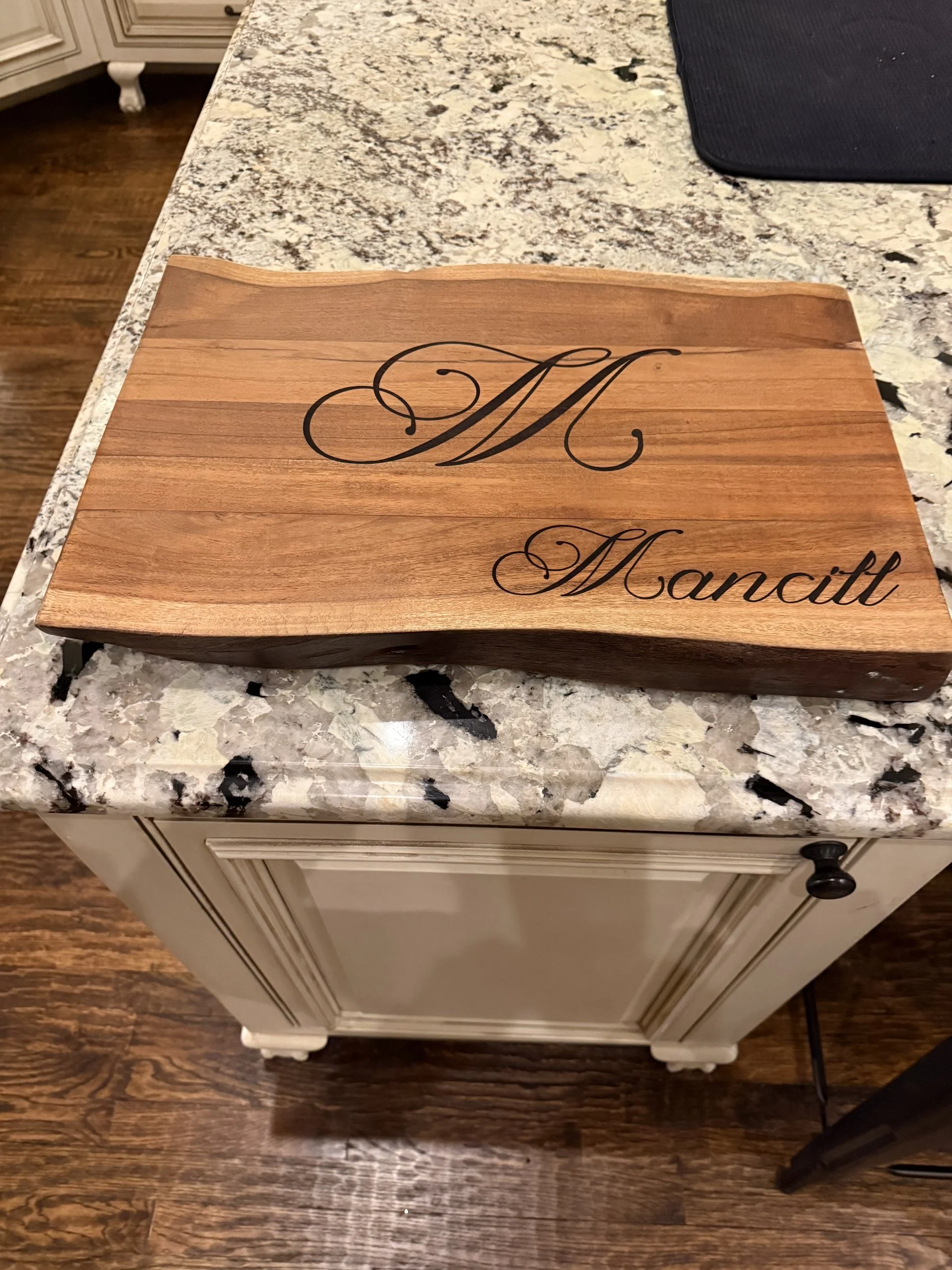 A wooden cutting board with a engraved custom laser-cut wood project showing fine detail