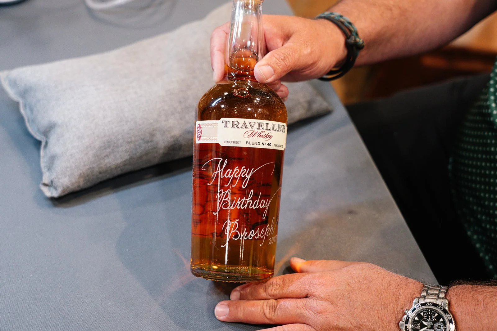 Elegant calligraphy engraved on whiskey bottle for special occasion