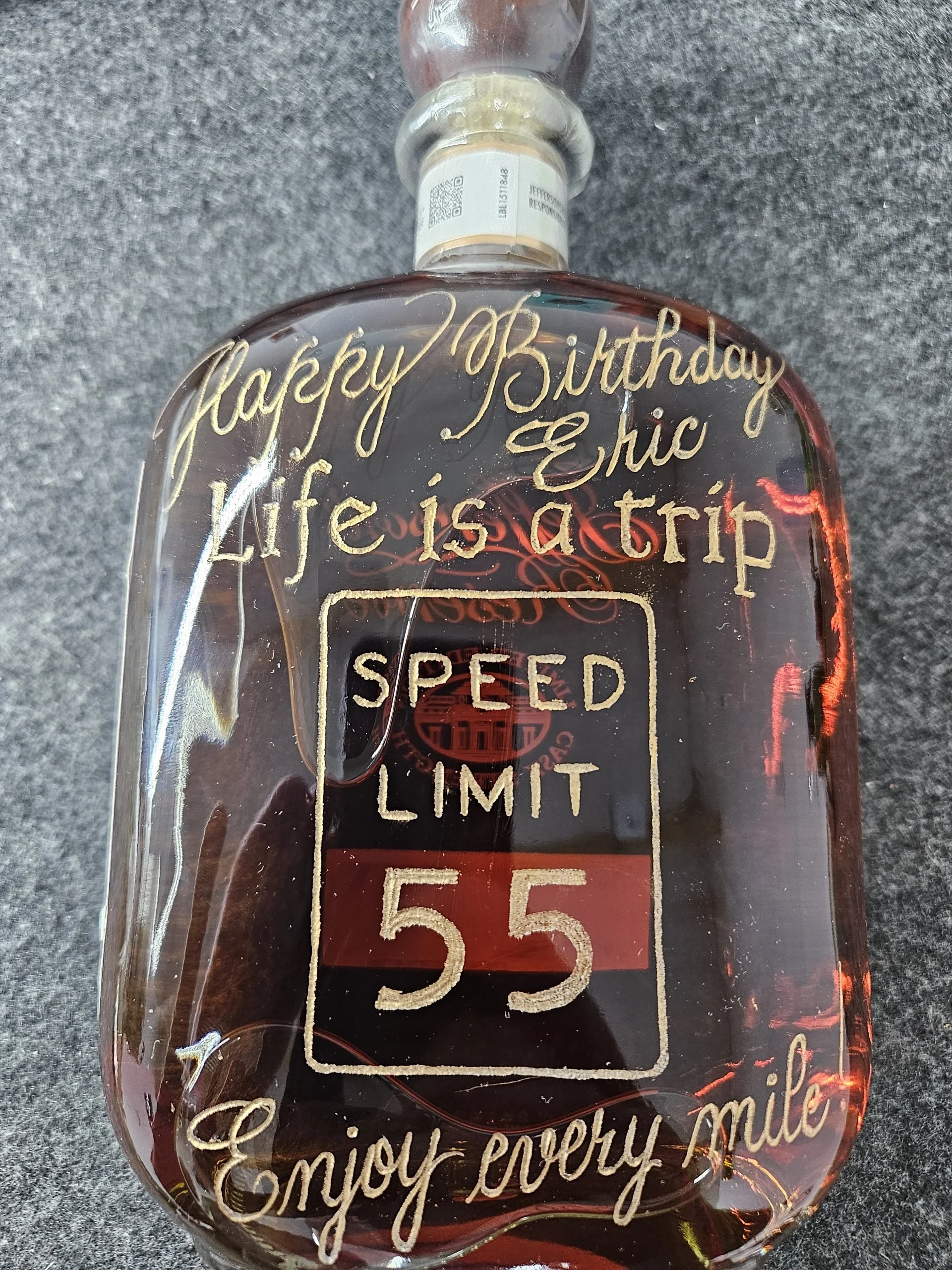 Elegant calligraphy engraved on whiskey bottle for special occasion