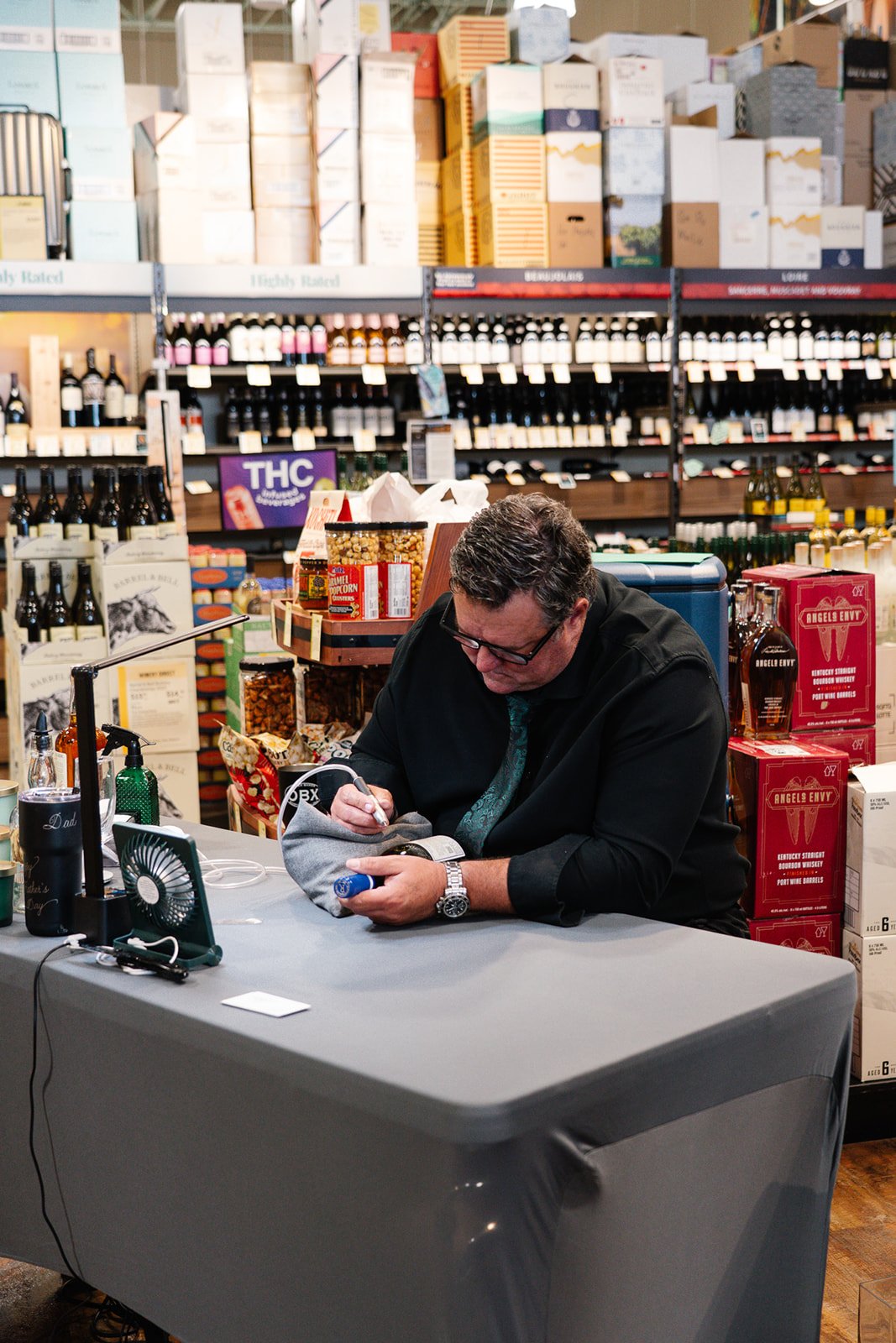 On-site wine bottle calligraphy service for retail activation
