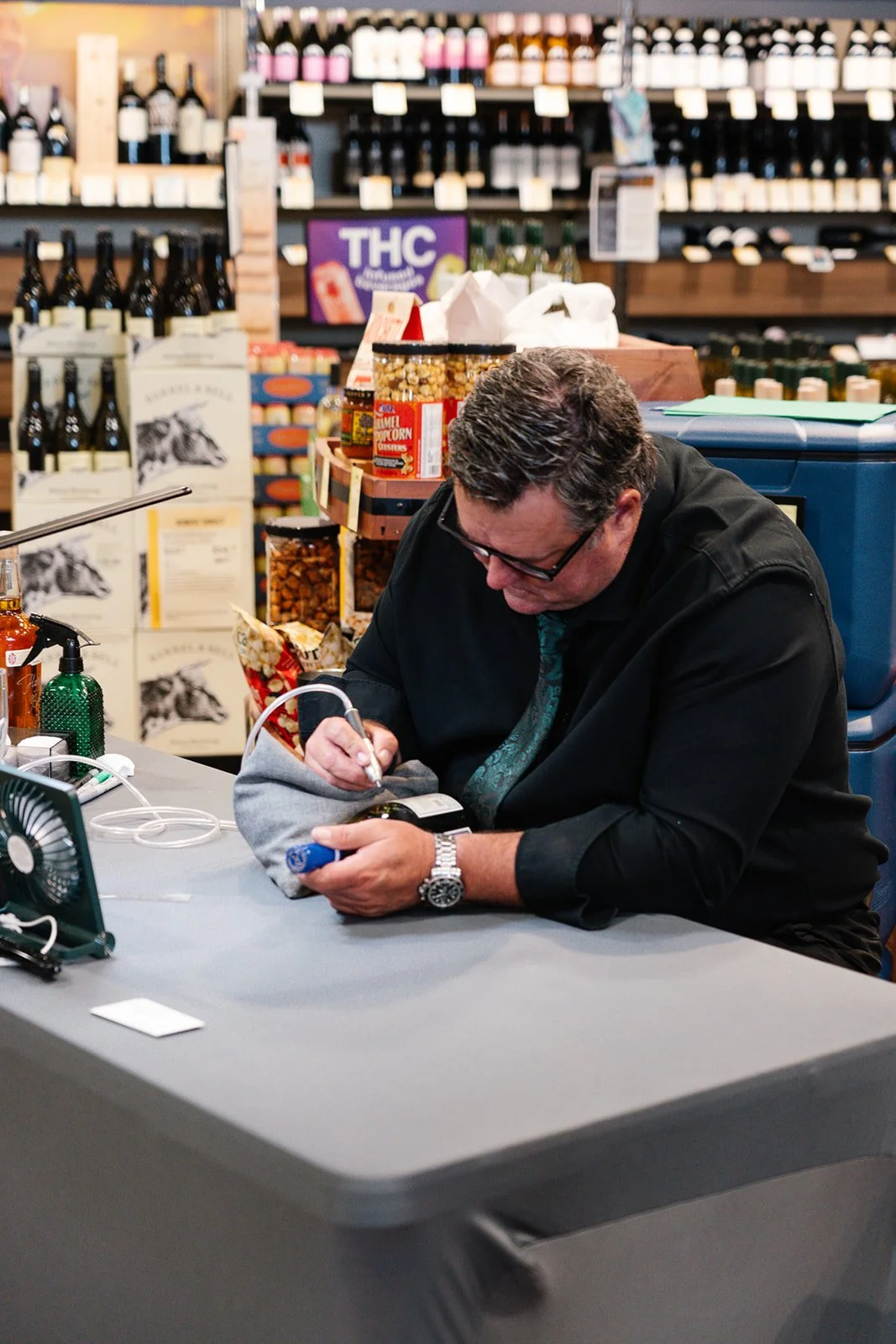 Grady working on custom engraving project in Total Wine store