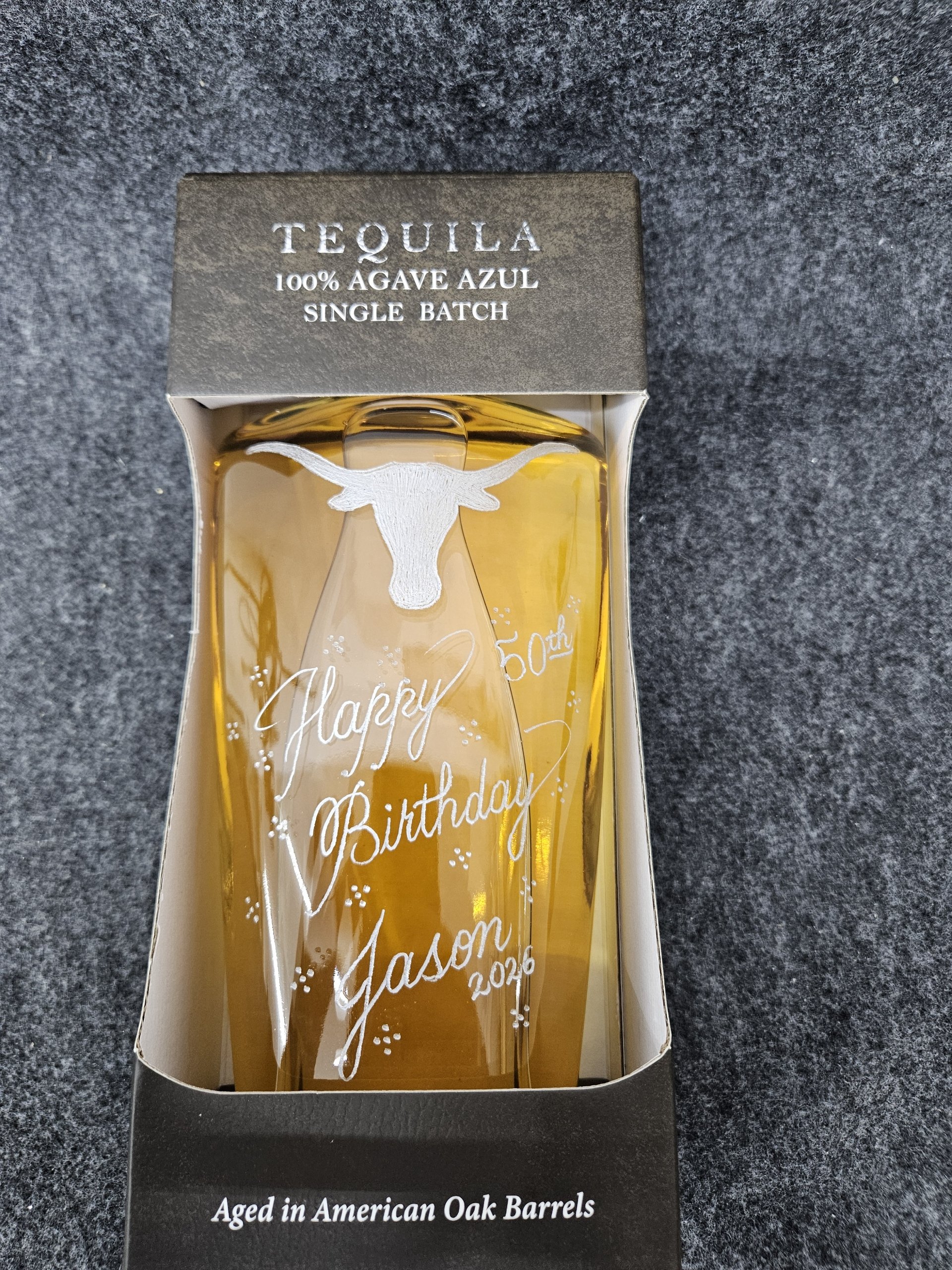 Elegant calligraphy engraved on whiskey bottle for special occasion