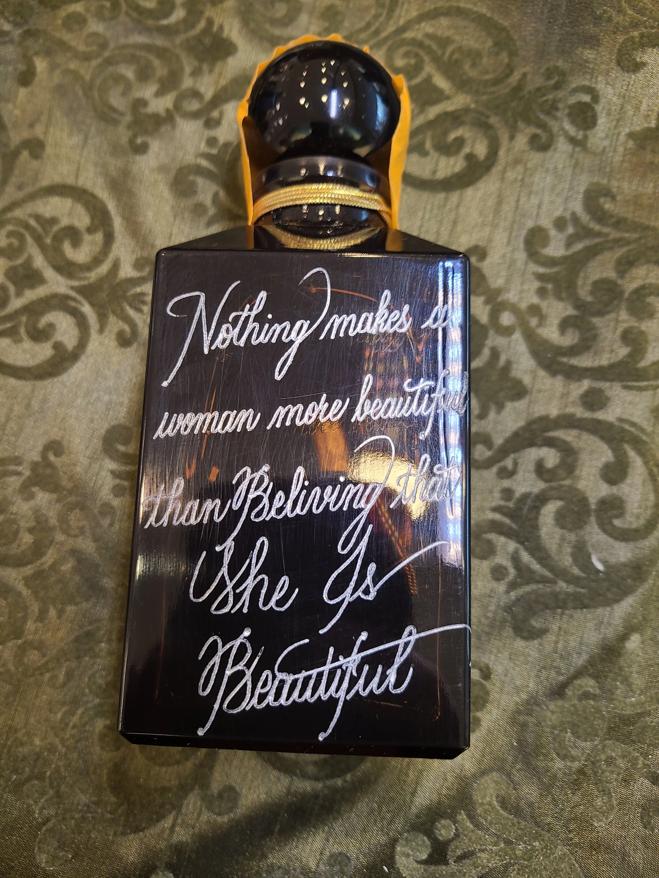 A perfume bottle with custom hand engraving note