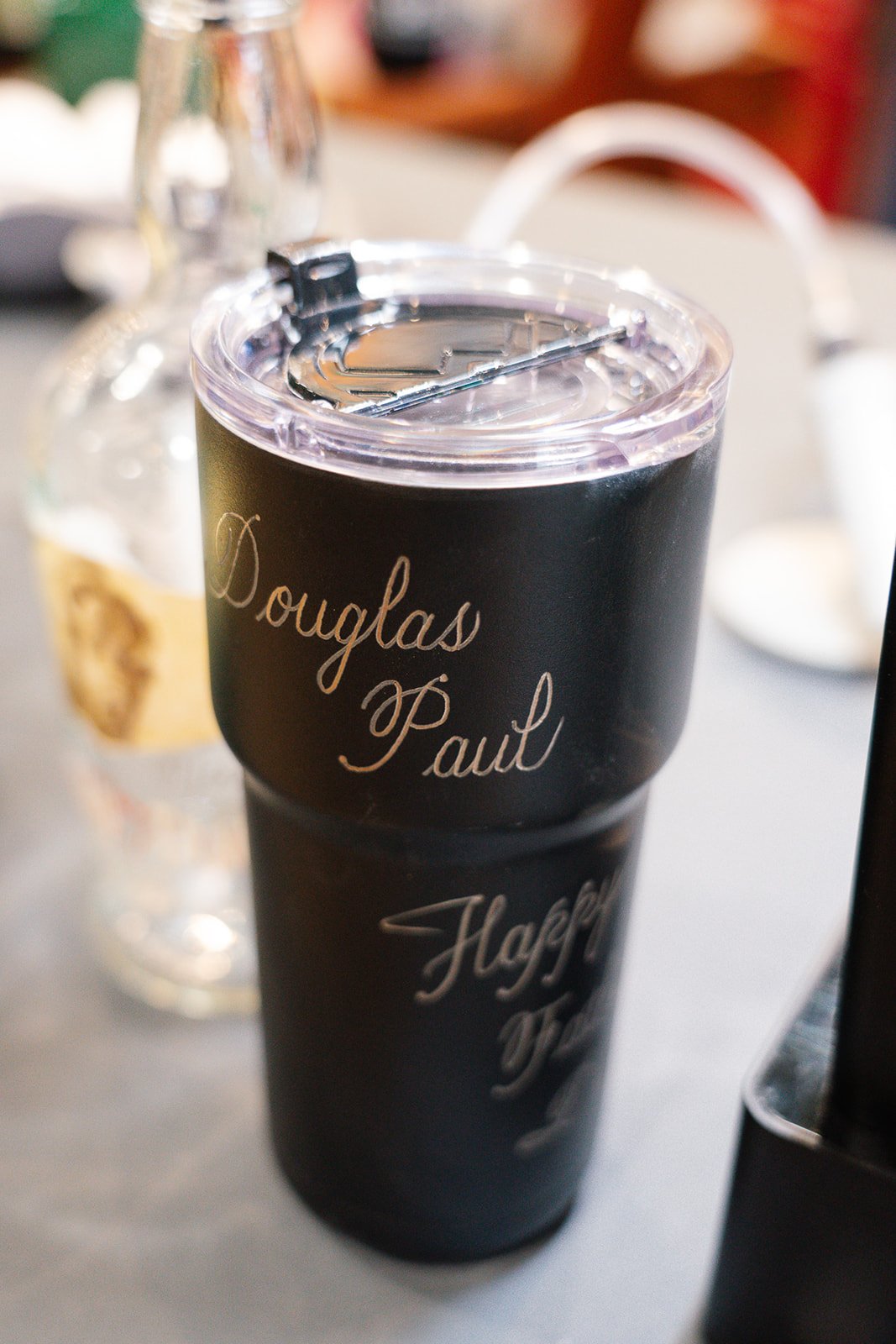 Travel tumbler with the cursive custom hand engraving