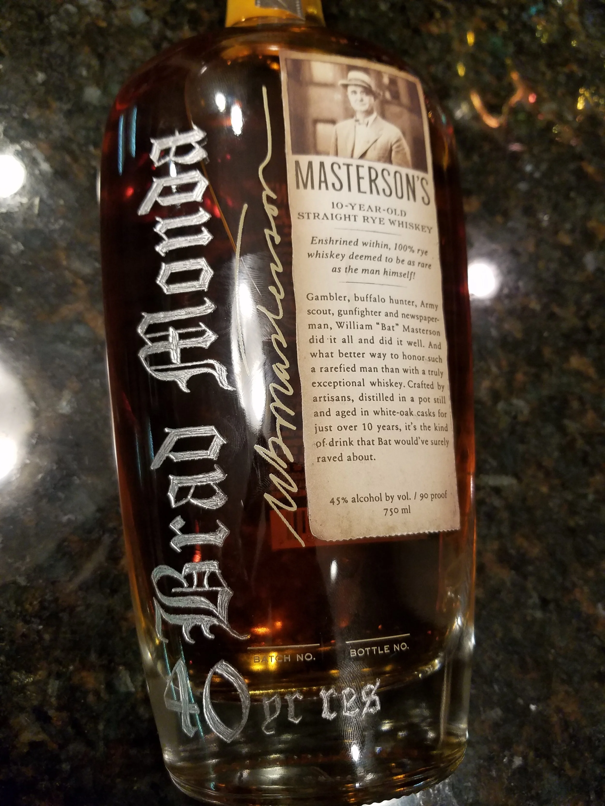 Elegant calligraphy engraved on whiskey bottle for special occasion