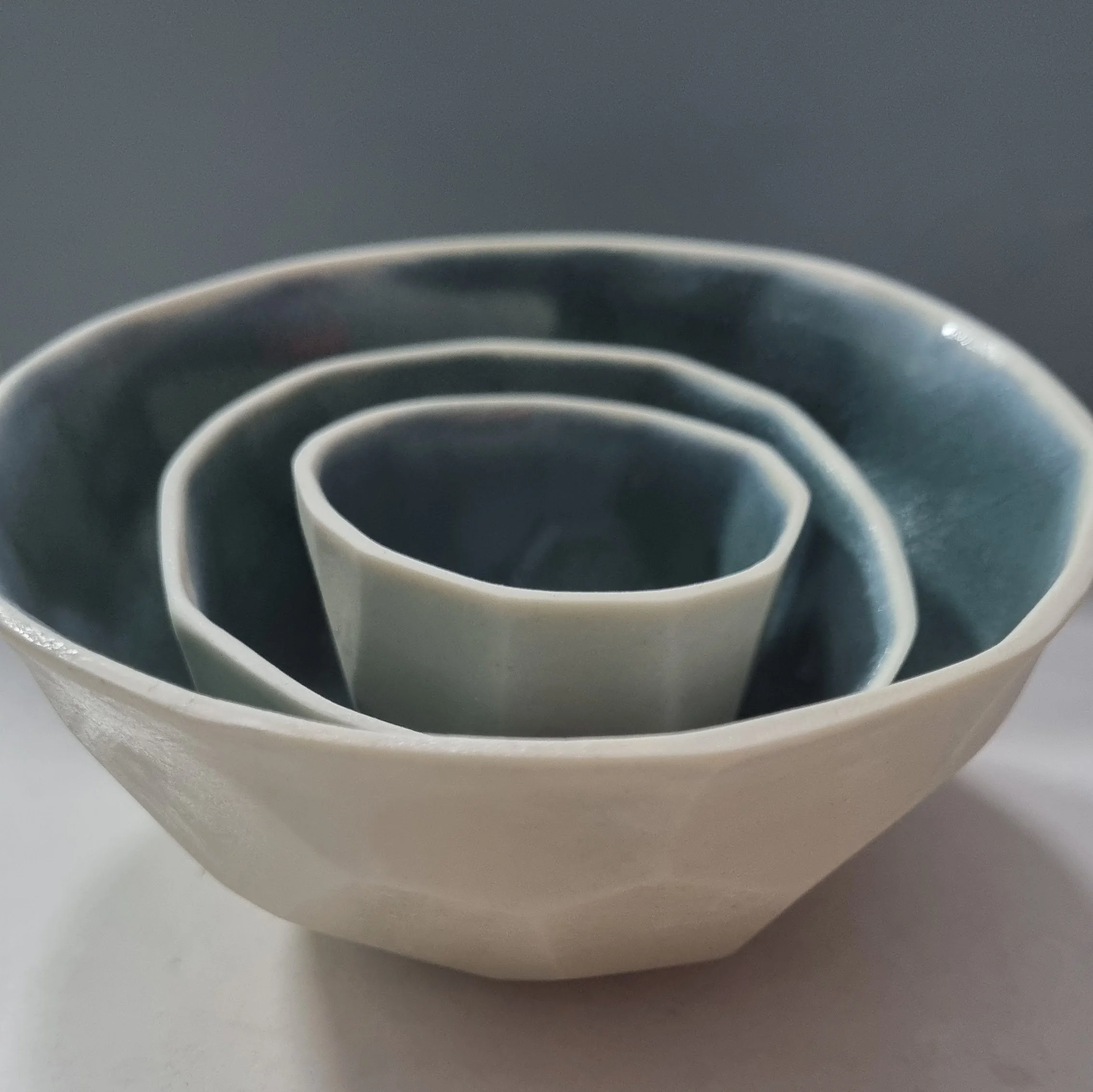 Slip cast porcelain with cobalt and copper glaze nesting vessels