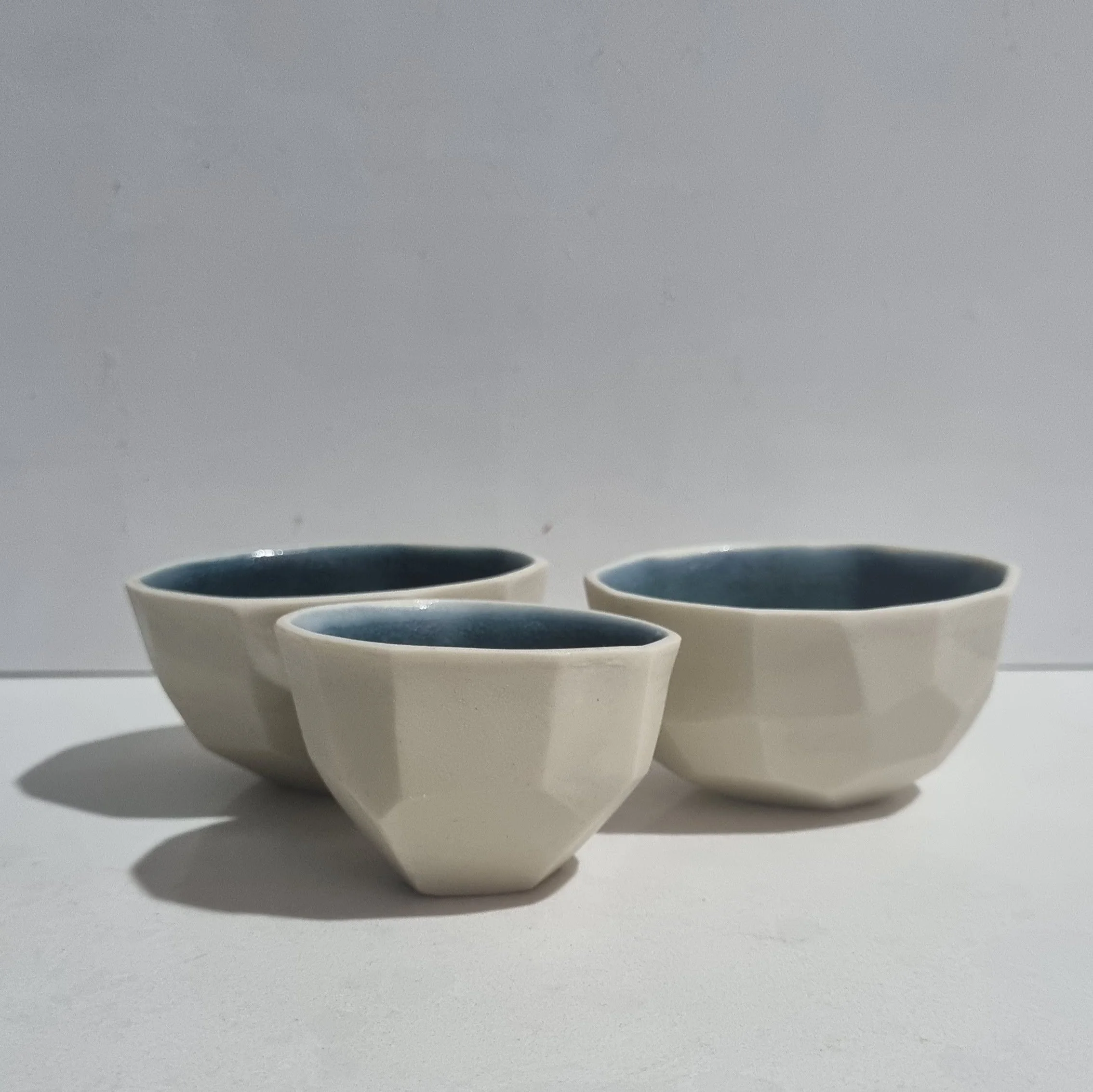 Faceted slip cast porcelain vessels