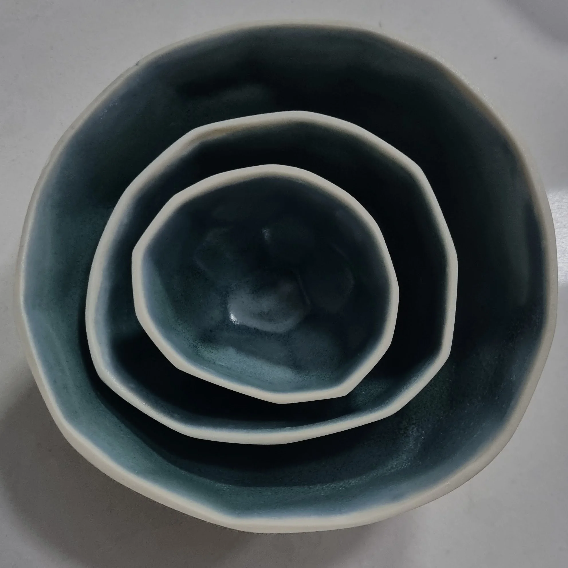 Slip cast porcelain with cobalt and copper glaze nesting vessels