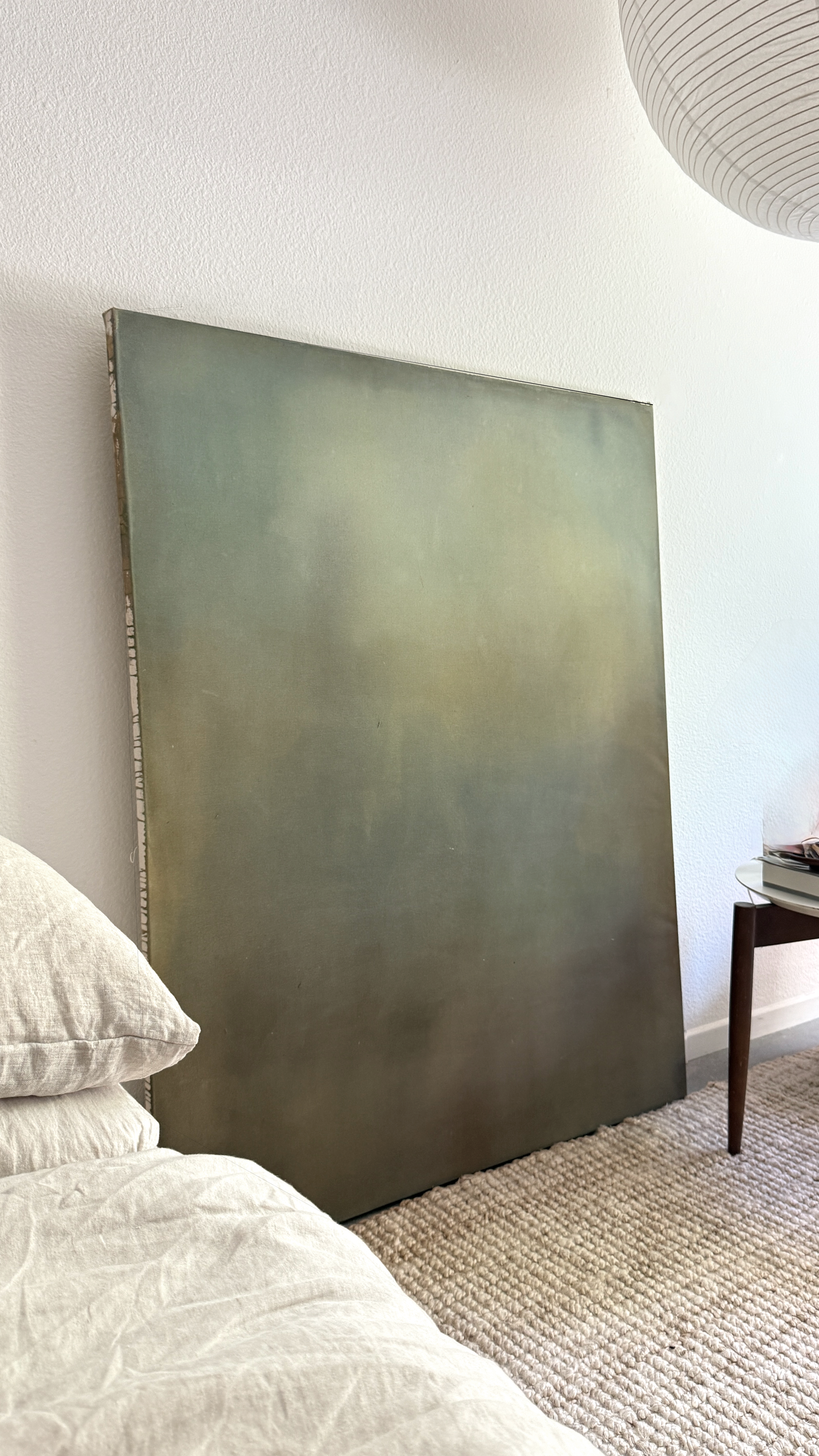 Minimal abstract painting in warm earth tones on raw canvas with fluid acrylic washes and organic texture.