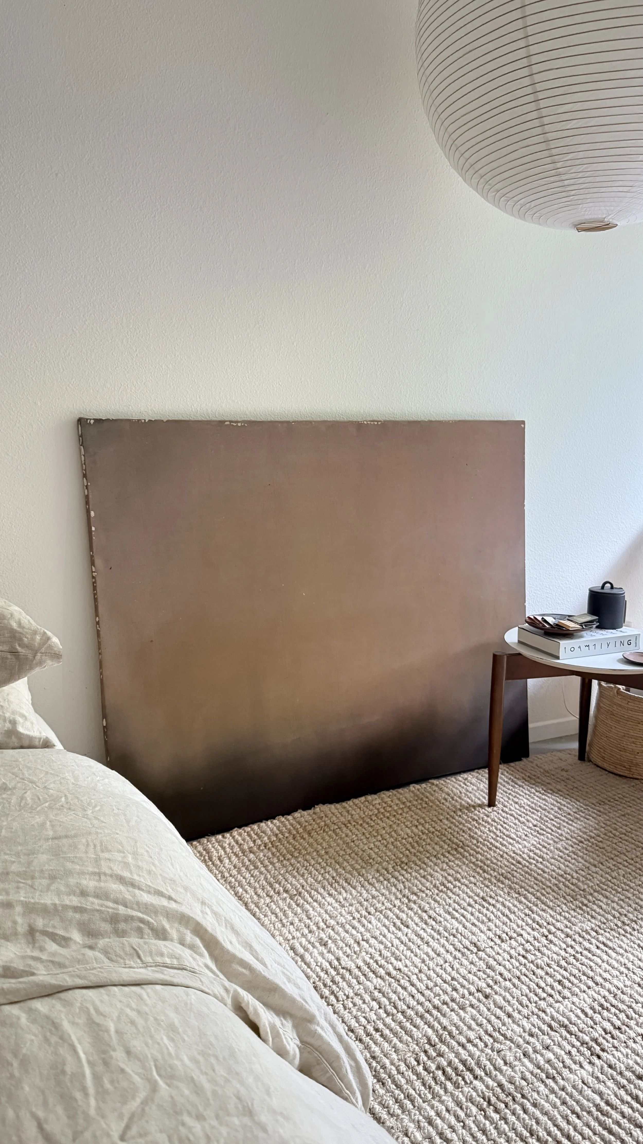 Minimal abstract painting in warm earth tones on raw canvas with fluid acrylic washes and organic texture.