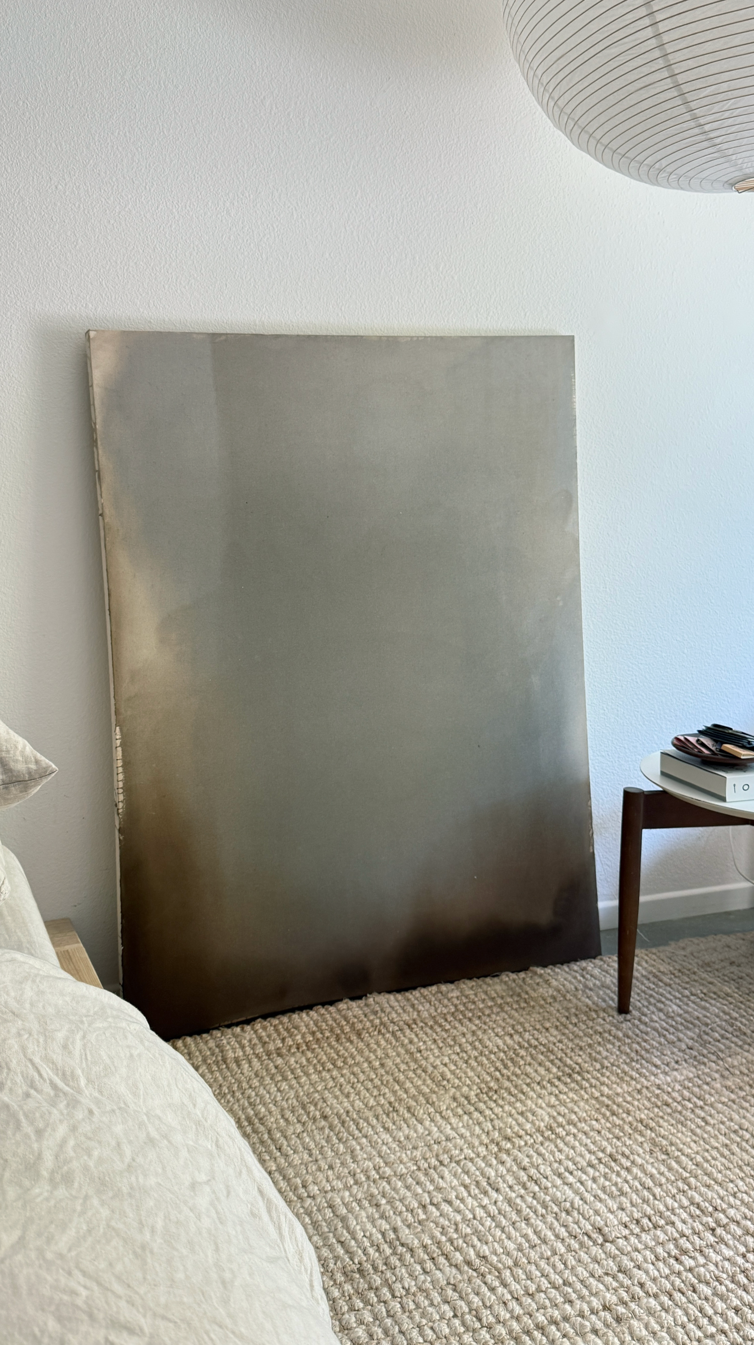 Minimal abstract painting in warm earth tones on raw canvas with fluid acrylic washes and organic texture.