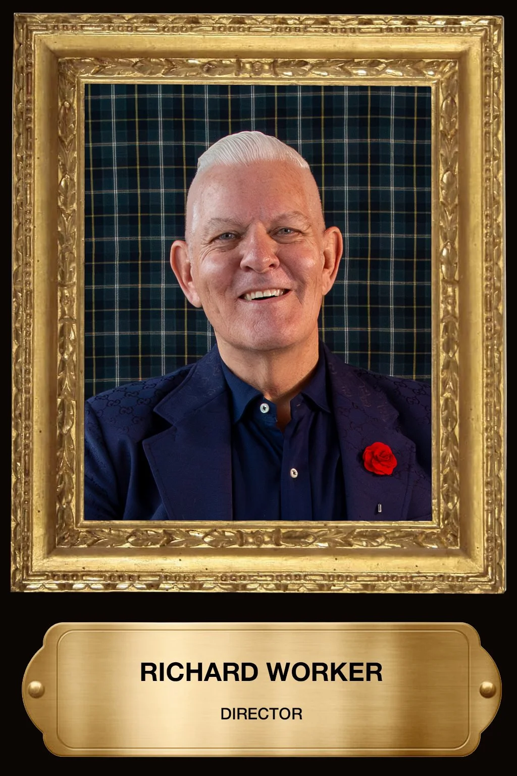 A portrait of Richard Worker, wearing a dark blue suit and a red rose lapel pin, inside a gold frame with a plaque that reads 'RICHARD WORKER, DIRECTOR', against a dark checkered background.
