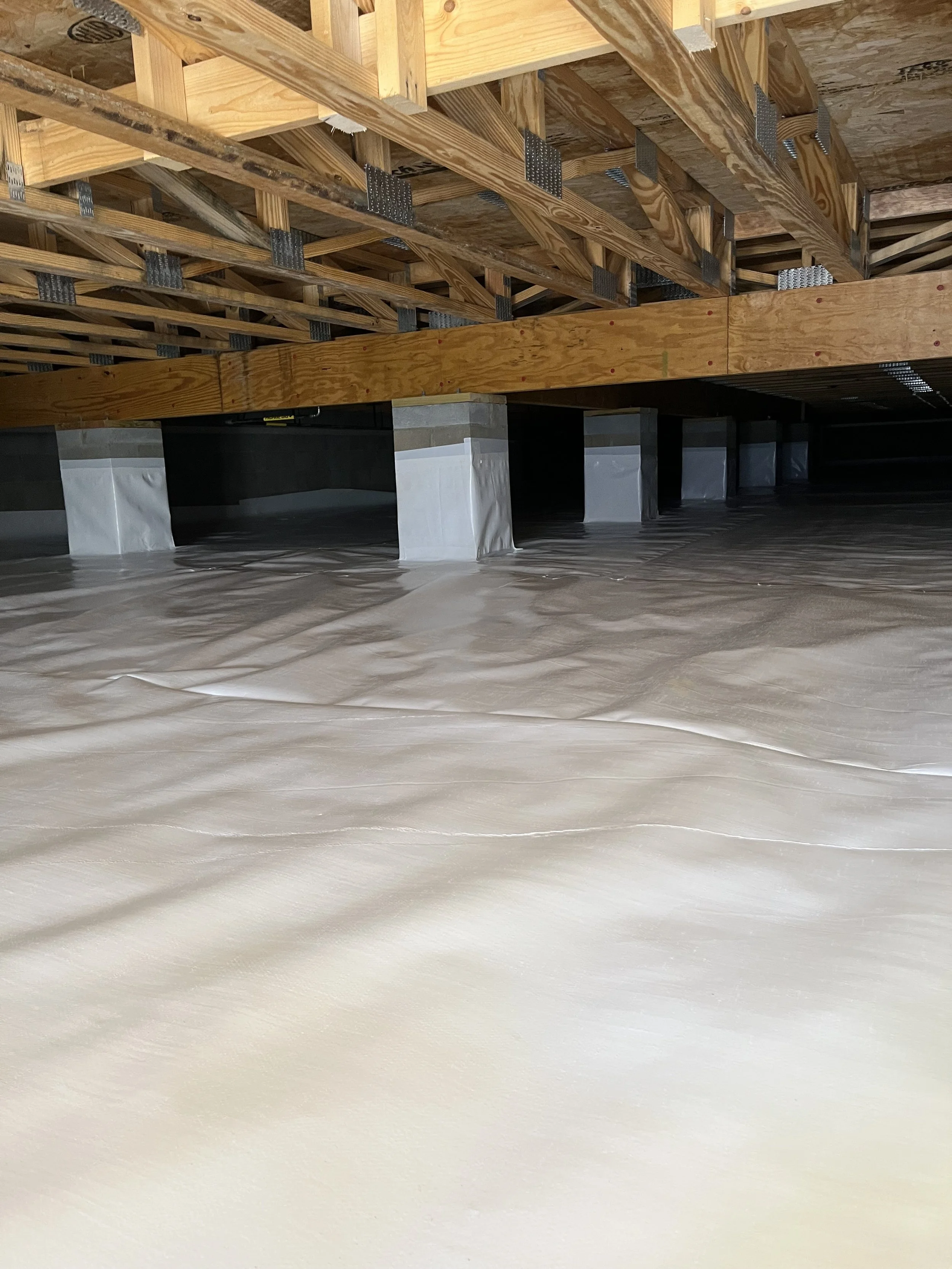 Construction site with wooden framing and insulation, view from below.