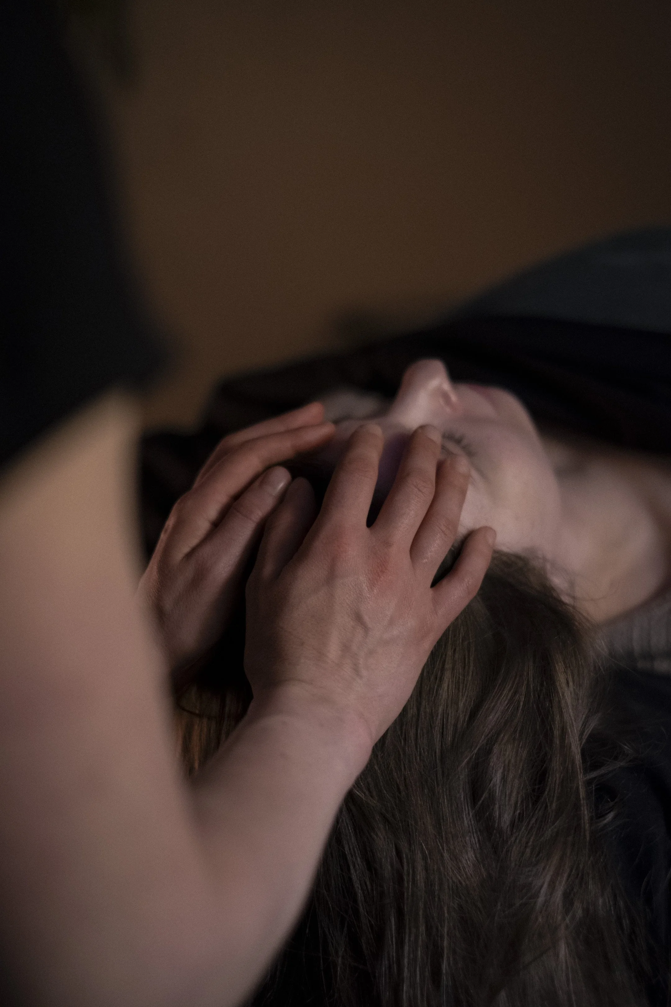 A practitioner offers a frontal lift in craniosacral therapy, supporting stillness, balance, and deep relaxation.