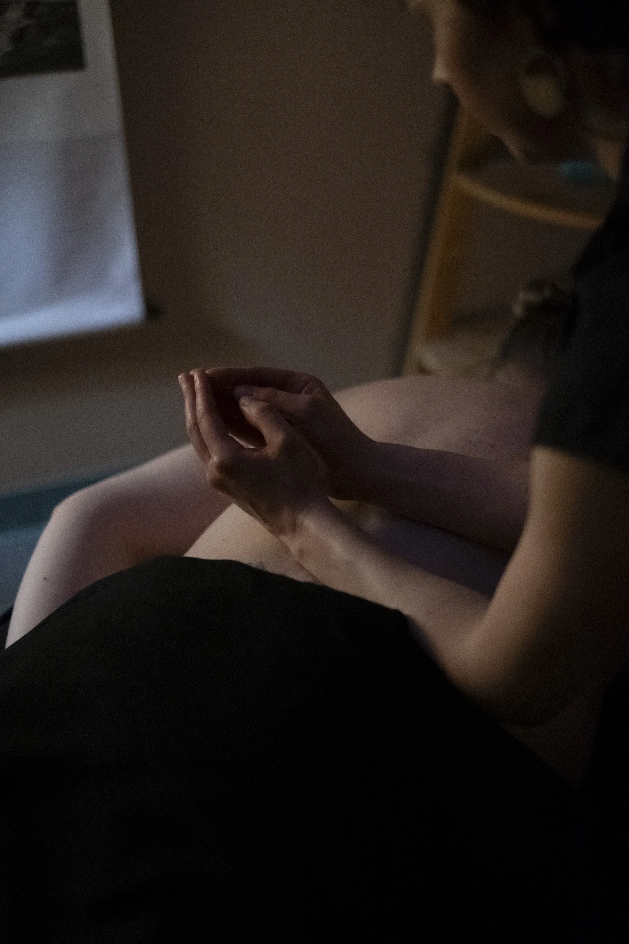 A massage therapist massages a client's lower and mid back, supporting release and relaxation during a treatment session.