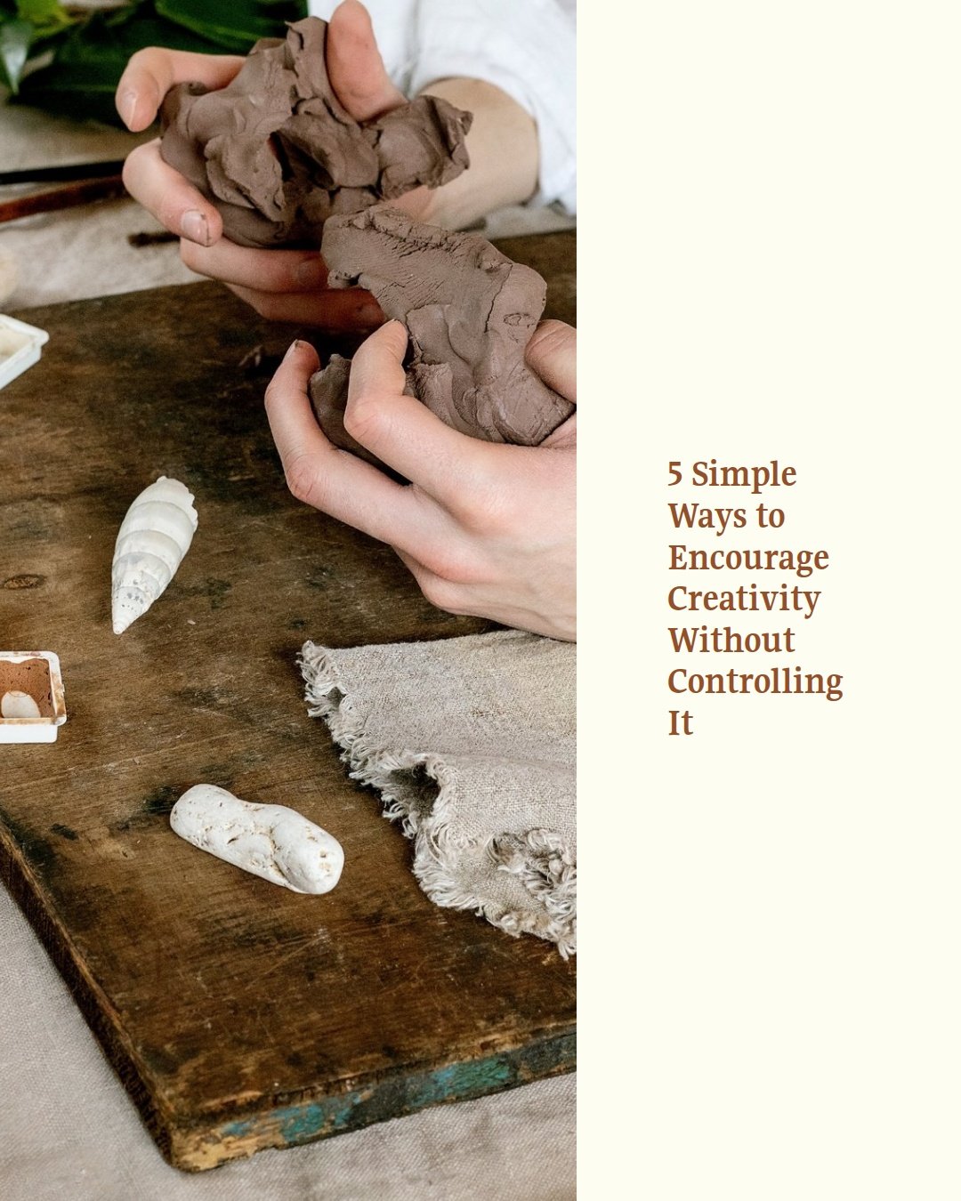 Person shaping gray clay with their hands on a wooden surface, with shells, a fabric cloth, and a small palette nearby.